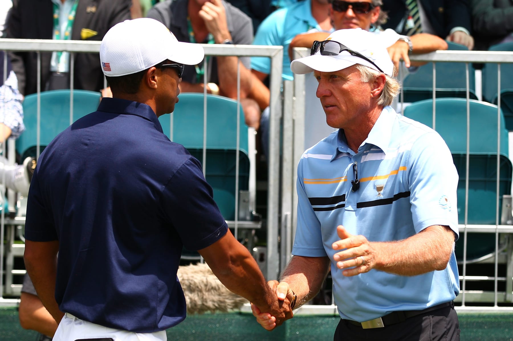 MELBOURNE, AUSTRALIA - NOVEMBER 17: (L-R) Tiger Woods of the U.S. Team and International Team captain Greg Norman shake hands on the first hole during the Day One Foursome Matches of the 2011 Presidents Cup at Royal Melbourne Golf Course on November 17, 2011 in Melbourne, Australia.  (Photo by Ryan Pierse/Getty Images)