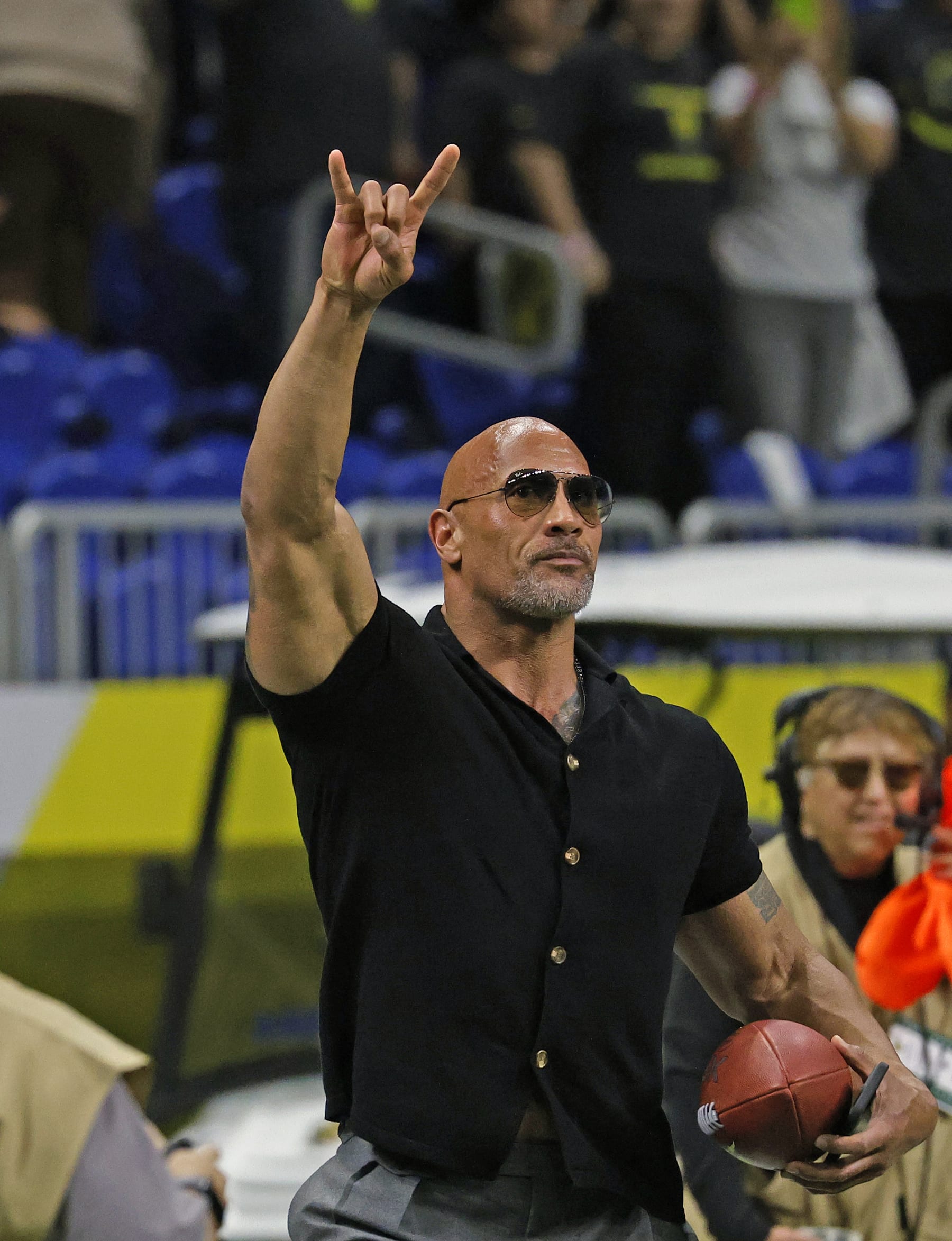 SAN ANTONIO, TX - FEBRUARY 19: Dwayne Johnson, co-owner of the XFL, acknowledges the crowd before the start of the game between the San Antonio Brahamas and the St. Louis Battlehawks at the Alamodome on February 19, 2023 in San Antonio, Texas.  (Photo by Ronald Cortes/Getty Images)
