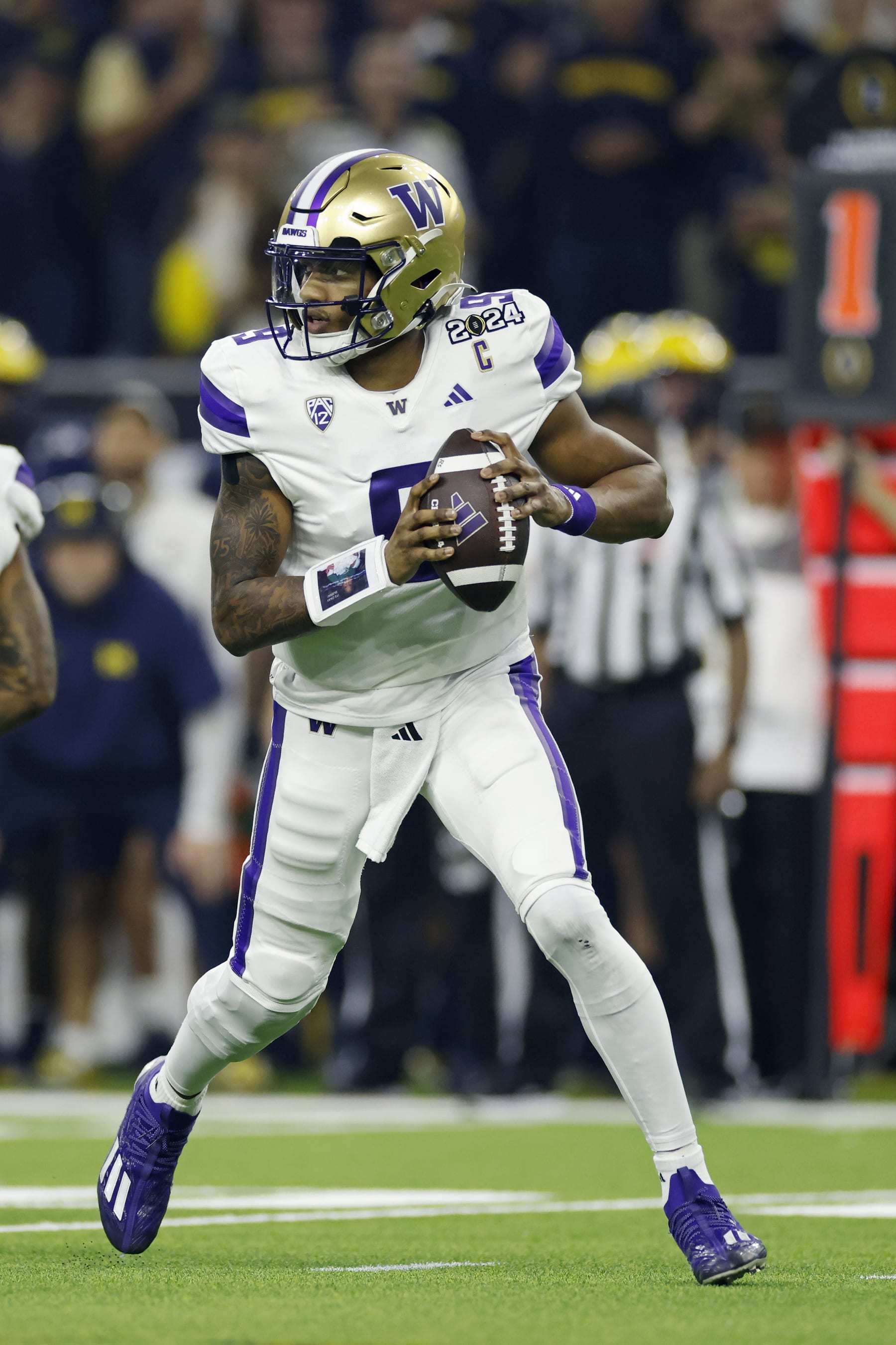 HOUSTON, TX - JANUARY 08: Washington Huskies quarterback Michael Penix Jr. (9) looks to pass the ball during the CFP National Championship against the Michigan Wolverines on January 08, 2024 at NRG Stadium in Houston, Texas. (Photo by Joe Robbins/Icon Sportswire via Getty Images)