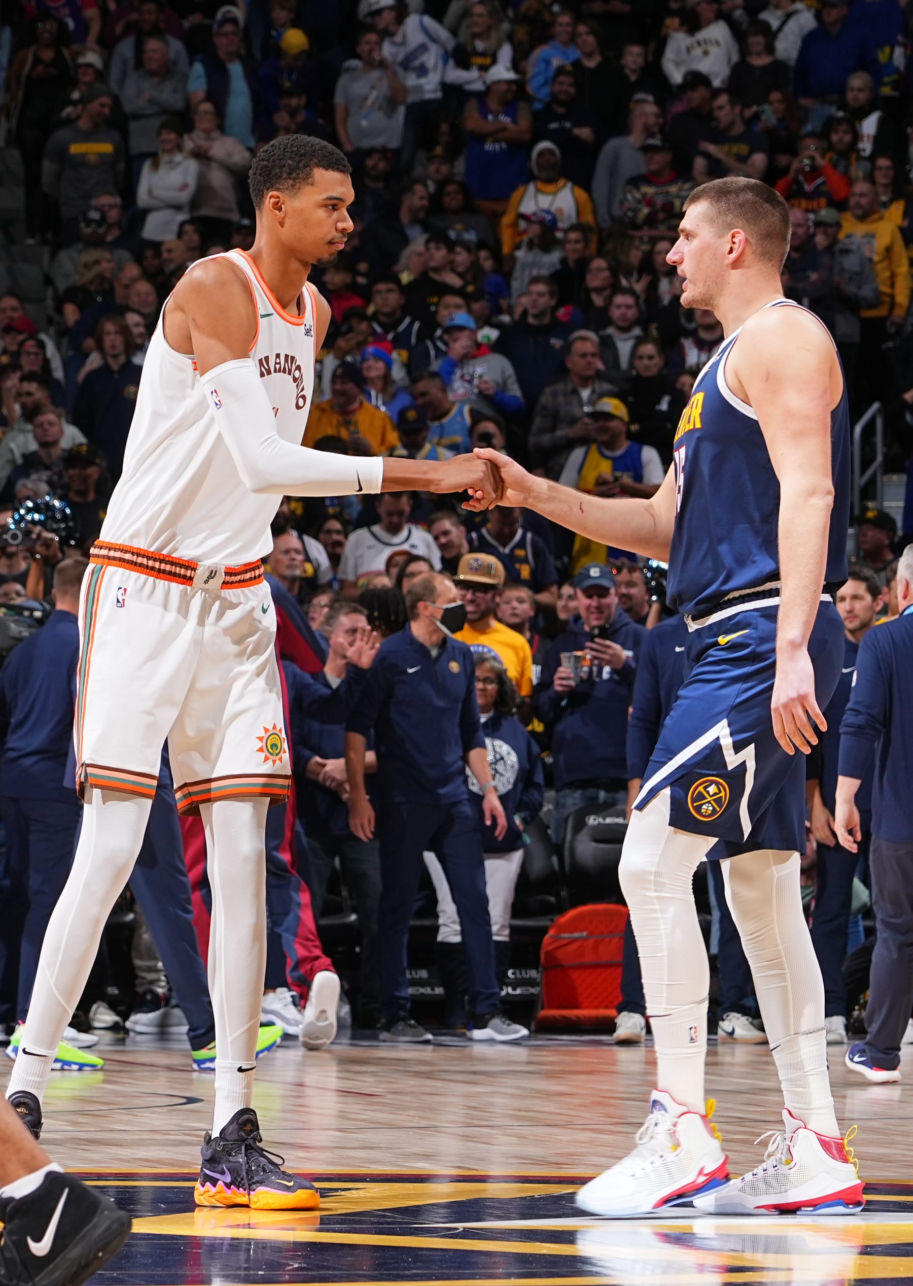 DENVER, CO - NOVEMBER 26: Victor Wembanyama #1 of the San Antonio Spurs high fives Nikola Jokic #15 of the Denver Nuggets during the game on November 26, 2023 at the Ball Arena in Denver, Colorado. NOTE TO USER: User expressly acknowledges and agrees that, by downloading and/or using this Photograph, user is consenting to the terms and conditions of the Getty Images License Agreement. Mandatory Copyright Notice: Copyright 2023 NBAE (Photo by Bart Young/NBAE via Getty Images)