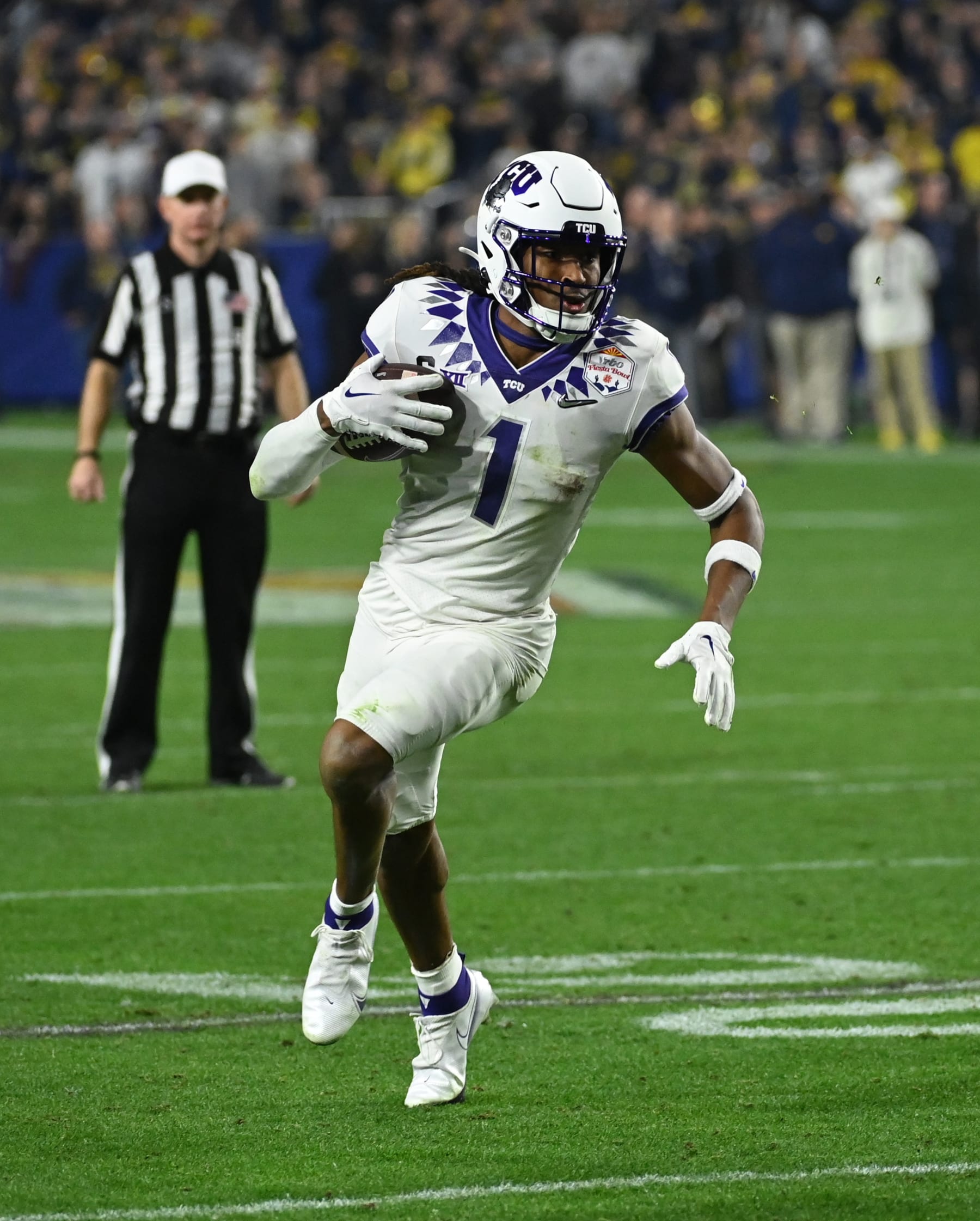 GLENDALE, ARIZONA - DECEMBER 31: Quentin Johnston #1 of the TCU Horned Frogs runs with the ball against the Michigan Wolverines during the Vrbo Fiesta Bowl at State Farm Stadium on December 31, 2022 in Glendale, Arizona. (Photo by Norm Hall/Getty Images)