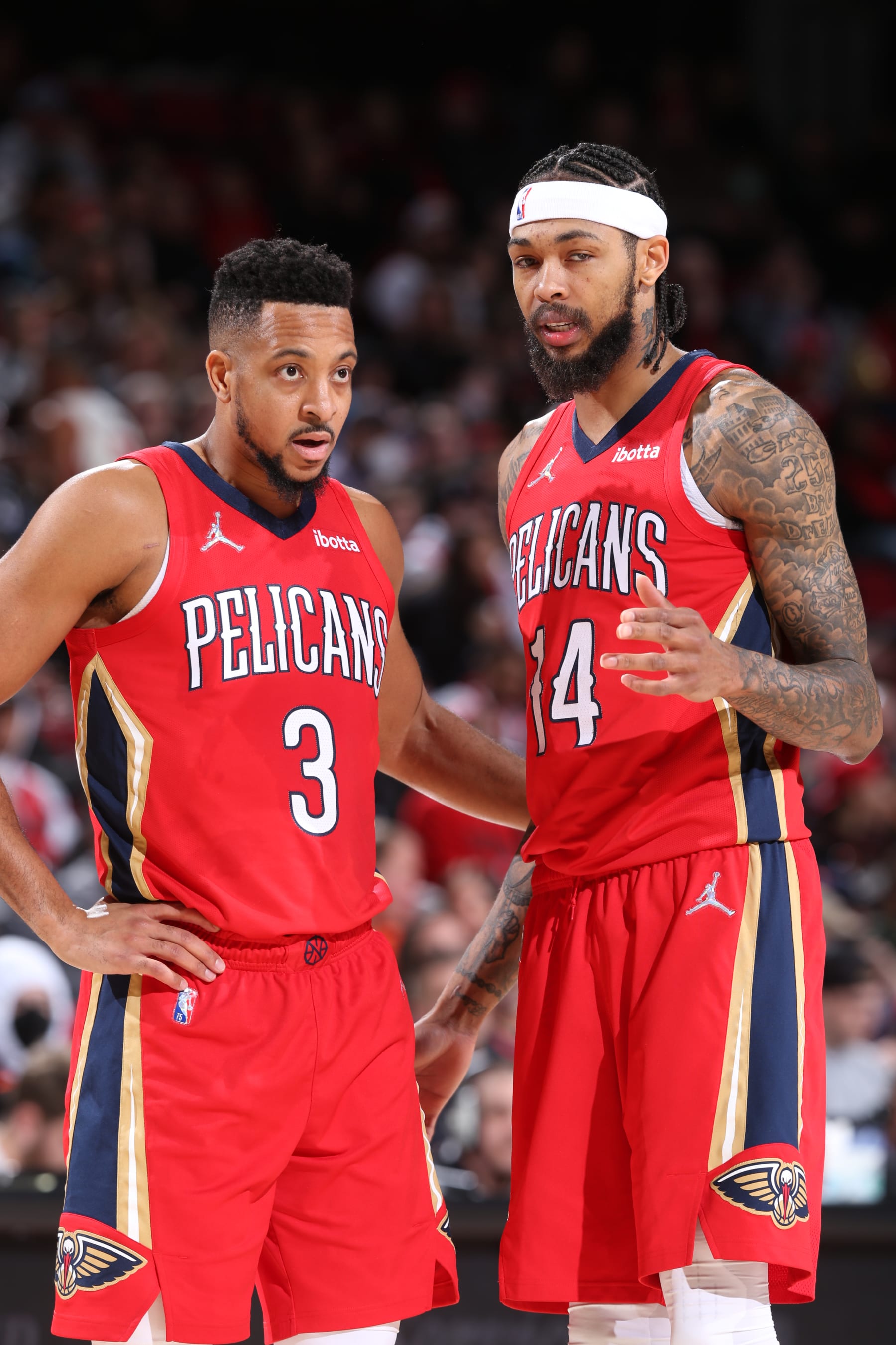 PORTLAND, OR - MARCH 30: CJ McCollum #3 and Brandon Ingram #14 of the New Orleans Pelicans talk during the game against the Portland Trail Blazers on March 30, 2022 at the Moda Center Arena in Portland, Oregon. NOTE TO USER: User expressly acknowledges and agrees that, by downloading and or using this photograph, user is consenting to the terms and conditions of the Getty Images License Agreement. Mandatory Copyright Notice: Copyright 2022 NBAE (Photo by Sam Forencich/NBAE via Getty Images)