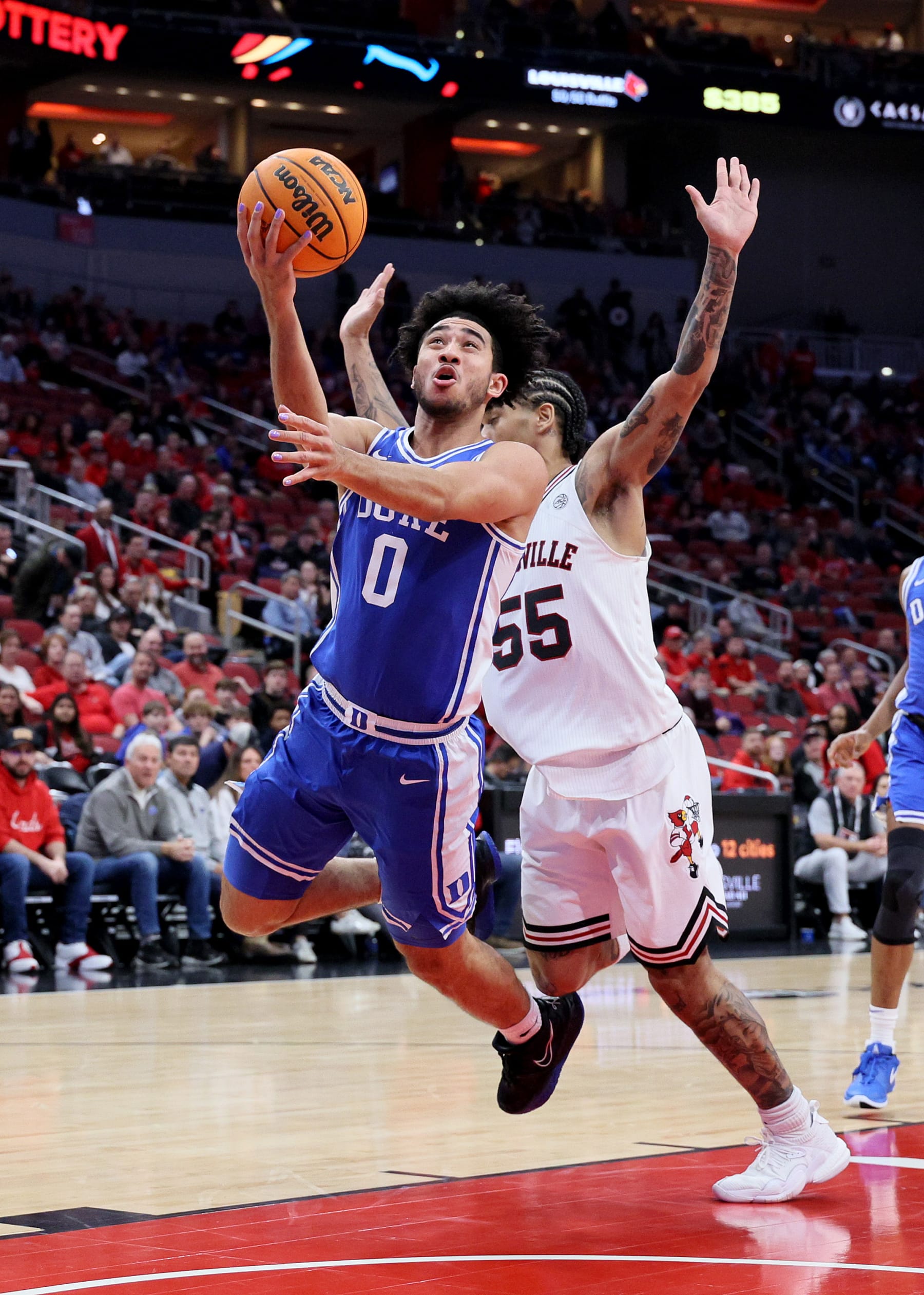 LOUISVILLE, KENTUCKY - JANUARY 23: Jared McCain #0 of the Duke Blue Devils shoots the ball while defended by Skyy Clark #55 of the Louisville Cardinals at KFC YUM! Center on January 23, 2024 in Louisville, Kentucky. (Photo by Andy Lyons/Getty Images)