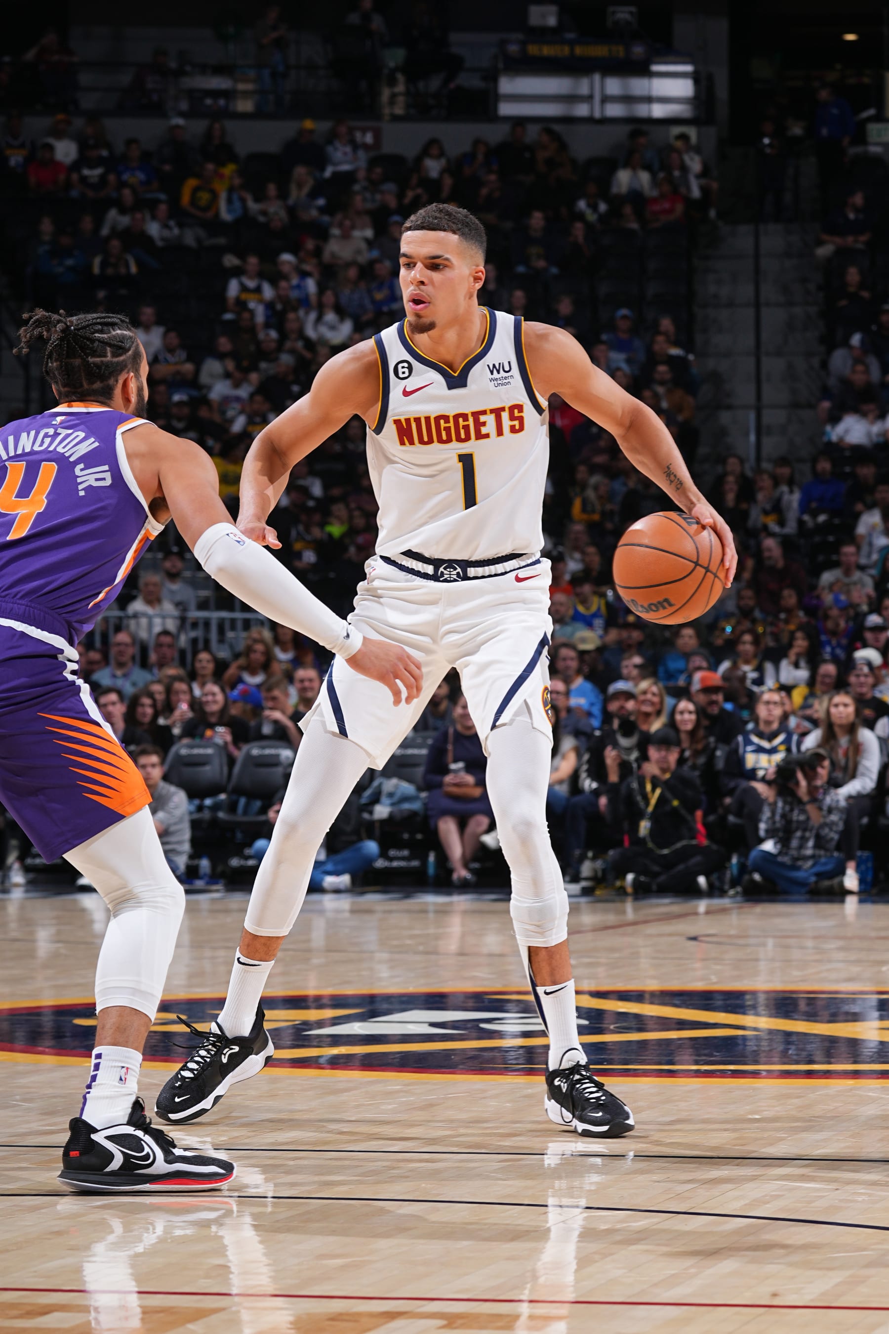 DENVER, CO - OCTOBER 10: Michael Porter Jr. #1 of the Denver Nuggets drives to the basket during the game against the Phoenix Suns on October 10, 2022 at the Ball Arena in Denver, Colorado. NOTE TO USER: User expressly acknowledges and agrees that, by downloading and/or using this Photograph, user is consenting to the terms and conditions of the Getty Images License Agreement. Mandatory Copyright Notice: Copyright 2022 NBAE (Photo by Bart Young/NBAE via Getty Images)