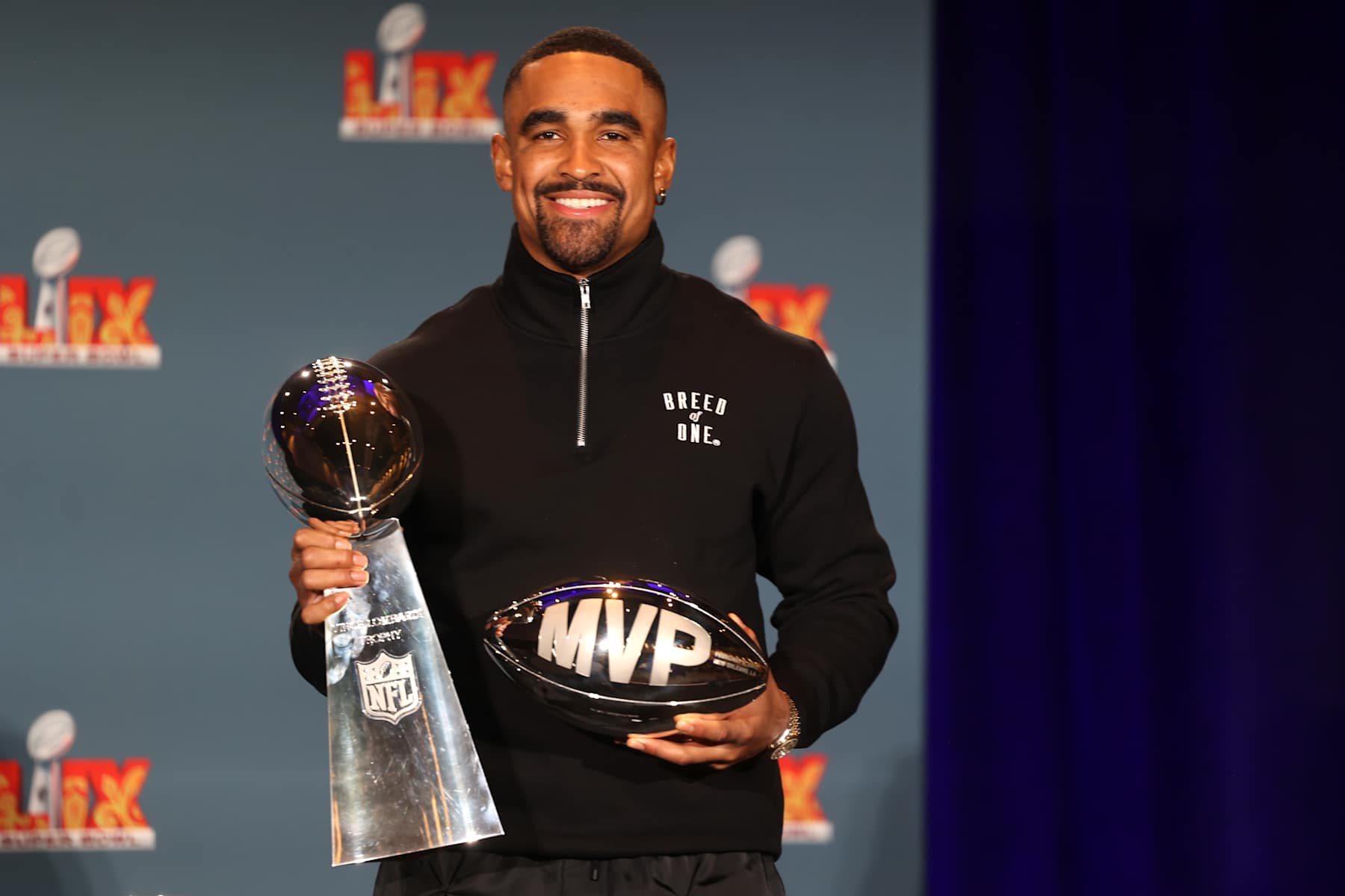 NEW ORLEANS, LOUISIANA - FEBRUARY 10:  Quarterback Jalen Hurts #1 of the Philadelphia Eagles, the MVP of Super Bowl LIX, holds both the MVP and Vince Lombardi trophies during a press conference at the Ernest N. Morial Convention Center on February 10, 2025 in New Orleans, Louisiana. The Eagles defeated the Kansas City Chiefs 40-22 in the Caesars Superdome on Sunday night. (Photo by Michael DeMocker/Getty Images)