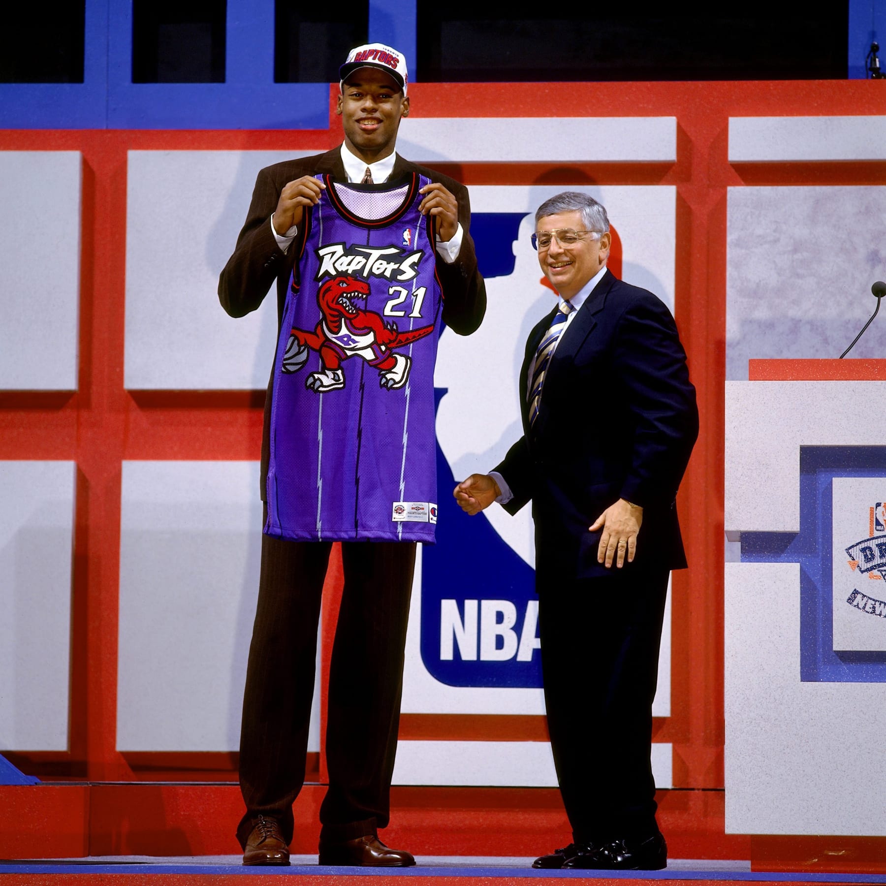 EAST RUTHERFORD, NJ - JUNE 26:  Marcus Camby holds a Toronto Raptors jersey with NBA Commissioner David Stern after he was selected number two overall by the Toronto Raptors in the first round of the 1996 NBA Draft on June 26, 1996 at the Continental Airlines Arena in East Rutherford, New Jersey.  NOTE TO USER: User expressly acknowledges and agrees that, by downloading and/or using this Photograph, user is consenting to the terms and conditions of the Getty Images License Agreement. Mandatory Copyright Notice: Copyright 1996 NBAE  (Photo by Andy Hayt/NBAE via Getty Images)