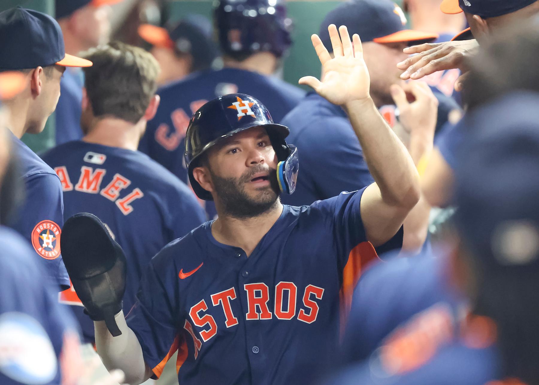 HOUSTON, TX - SEPTEMBER 08:  Houston Astros second baseman Jose Altuve (27) gets high fives from teammates after scoring a run in the bottom of the fifth inning during the MLB game between the Arizona Diamondbacks and Houston Astros on September 8, 2024 at Minute Maid Park in Houston, Texas.  (Photo by Leslie Plaza Johnson/Icon Sportswire via Getty Images)
