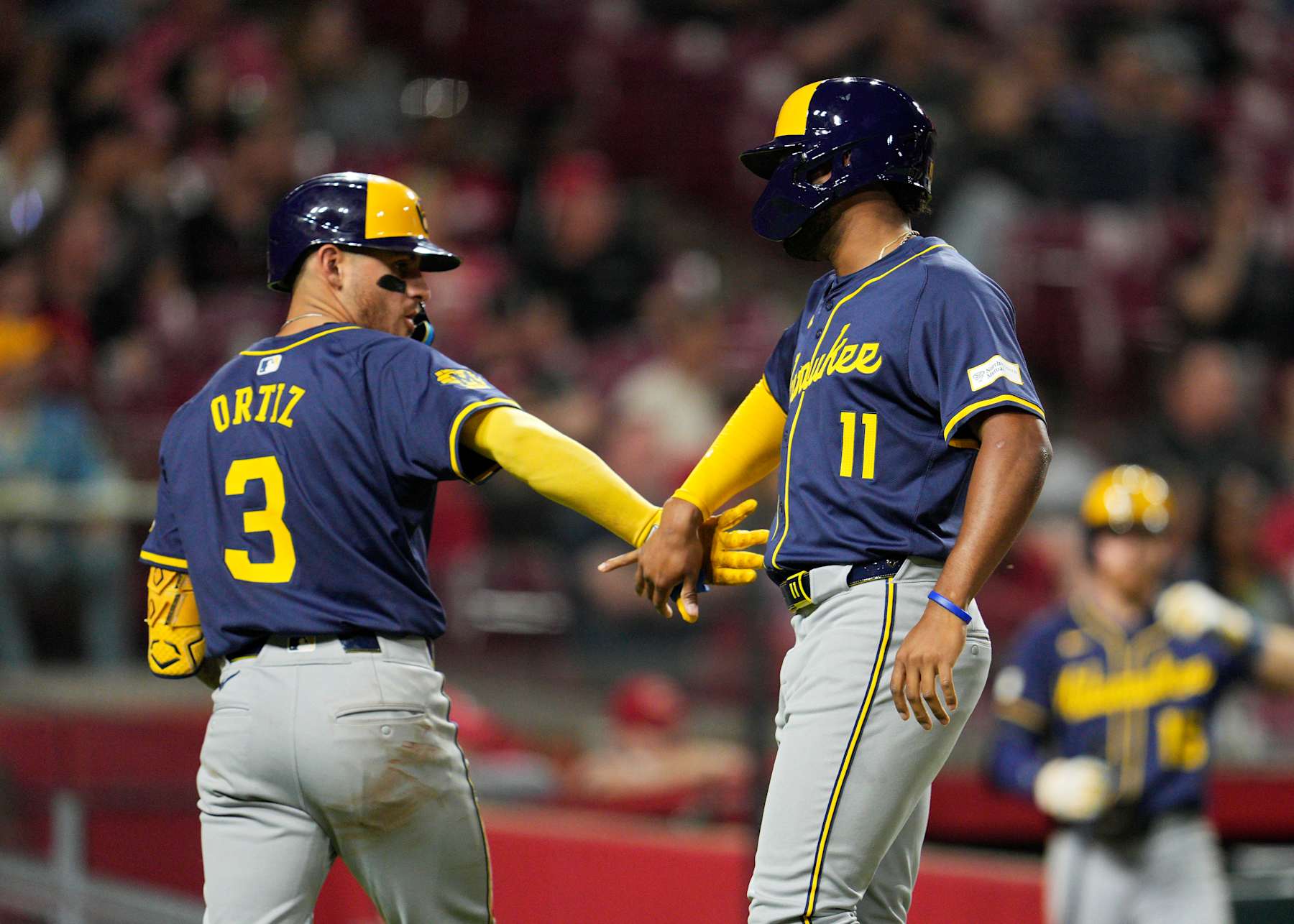 CINCINNATI, OHIO - APRIL 08: Jackson Chourio #11 of the Milwaukee Brewers celebrates with Joey Ortiz #3 of the Milwaukee Brewers after scoring on a Brice Turang #2 double in the sixth inning of a baseball game against the Cincinnati Reds at Great American Ball Park on April 08, 2024 in Cincinnati, Ohio. (Photo by Jeff Dean/Getty Images)