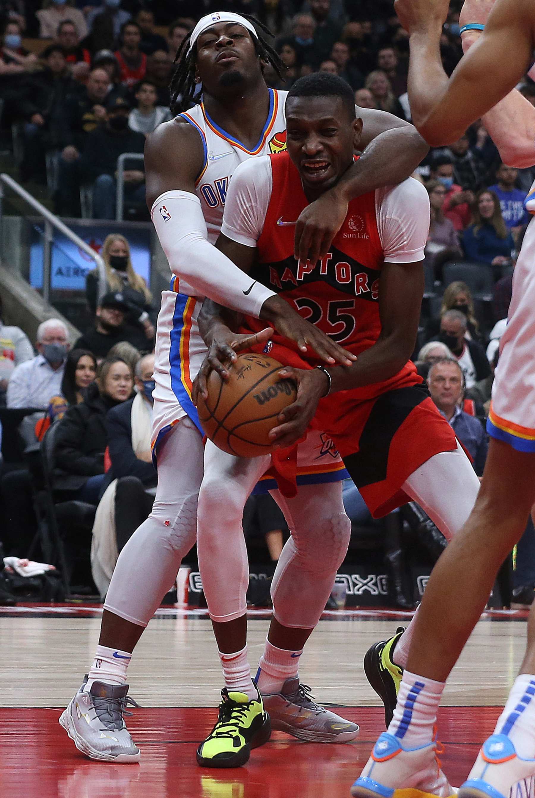 TORONTO, ON- DECEMBER 8  -  Oklahoma City Thunder forward Luguentz Dort (5) fouls Toronto Raptors forward Chris Boucher (25) as the Toronto Raptors play the Oklahoma City Thunder at Scotiabank Arena in Toronto. December 8, 2021.        (Steve Russell/Toronto Star via Getty Images)
