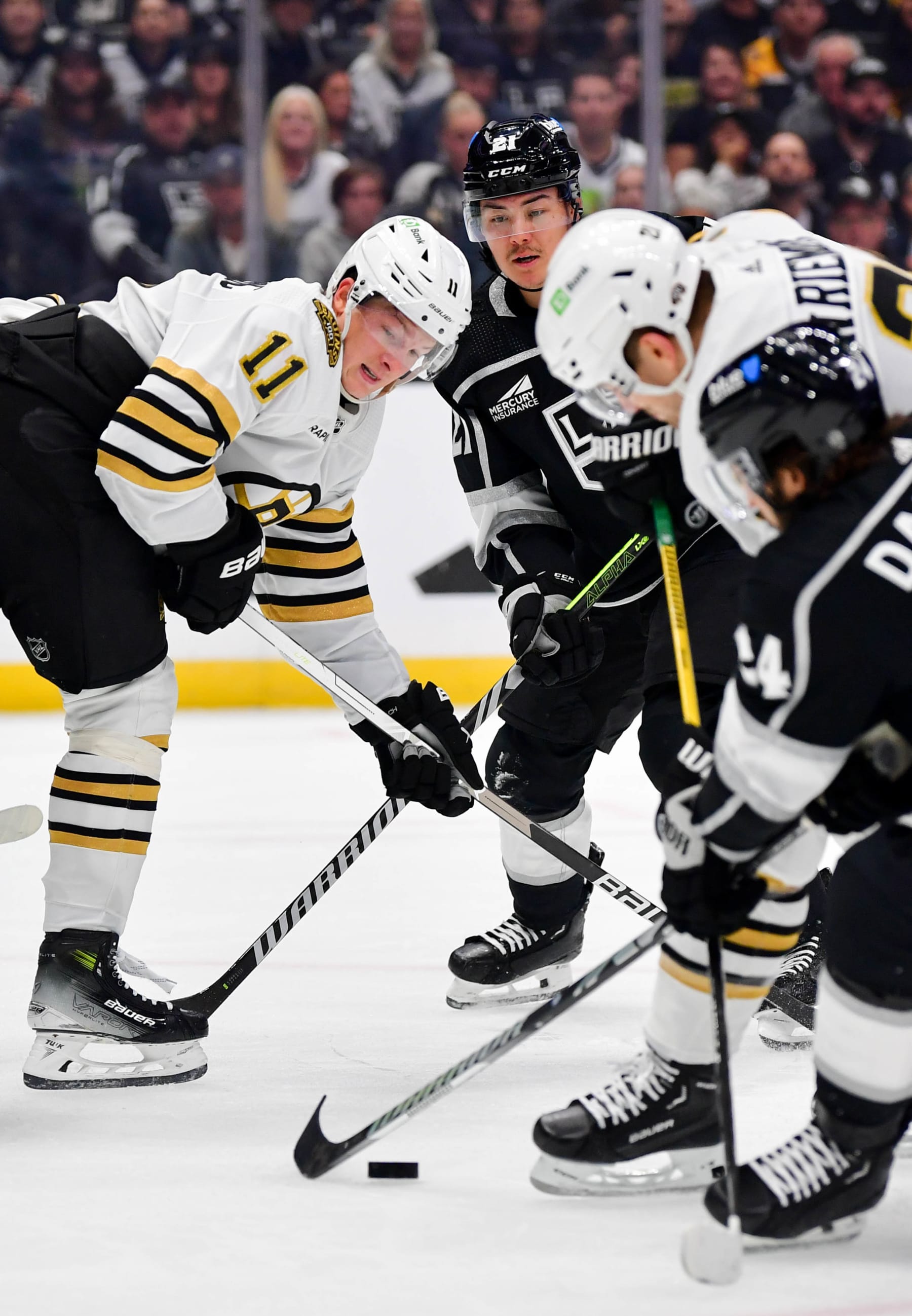 LOS ANGELES, CA - OCTOBER 21: Trent Frederic #11 of the Boston Bruins and Jordan Spence#21 of the Los Angeles Kings battle for position during the second period at Crypto.com Arena on October 21, 2023 in Los Angeles, California. (Photo by Gary A. Vasquez/NHLI via Getty Images)