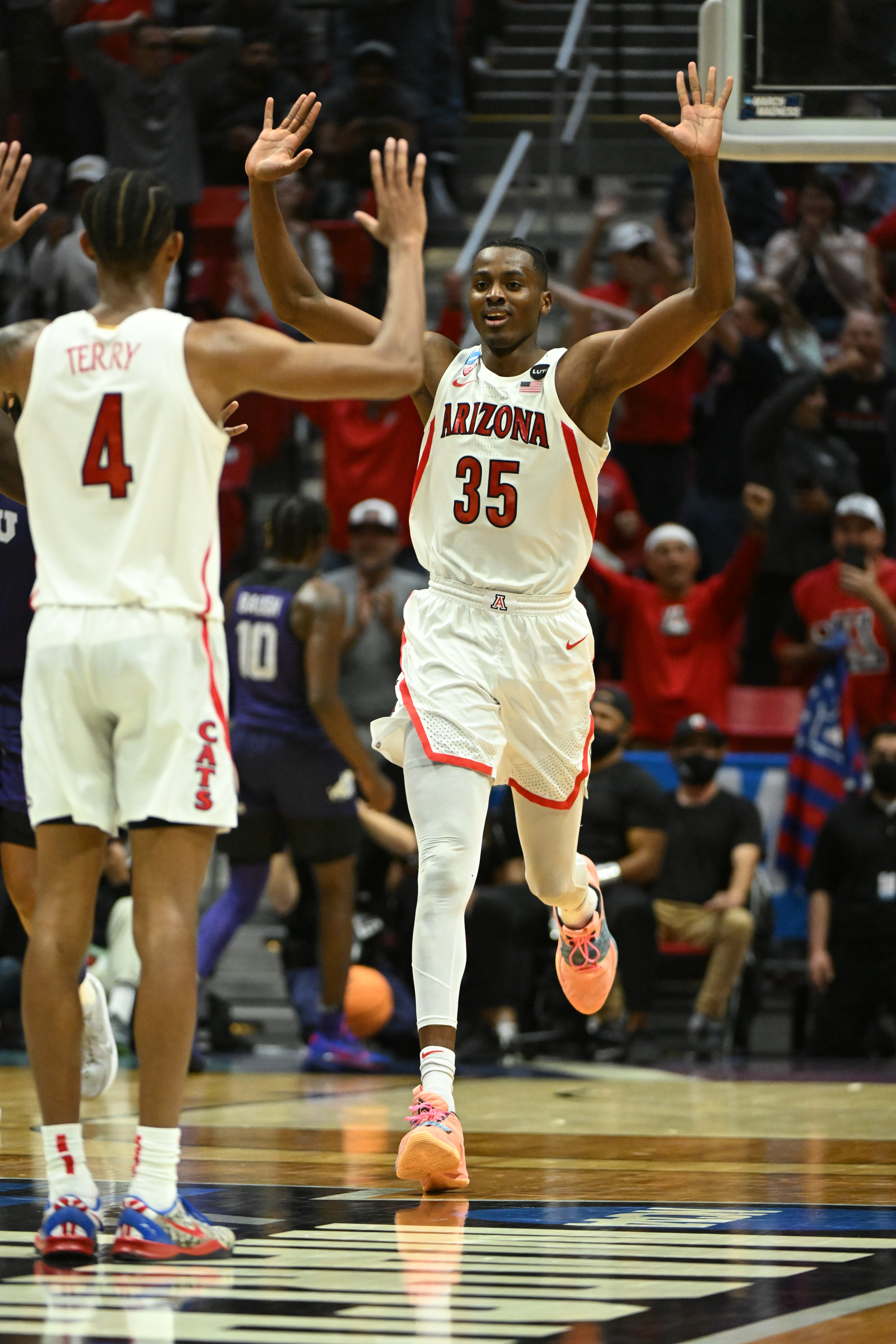 SAN DIEGO, CA - MARCH 20: Dalen Terry #4 of the Arizona Wildcats waits to celebrate with teammate Christian Koloko #35 of the Arizona Wildcats after his overtime dunk during the second round of the 2022 NCAA Men's Basketball Tournament held at Viejas Arena on March 20, 2022 in San Diego, California. (Photo by Brett Wilhelm/NCAA Photos via Getty Images)