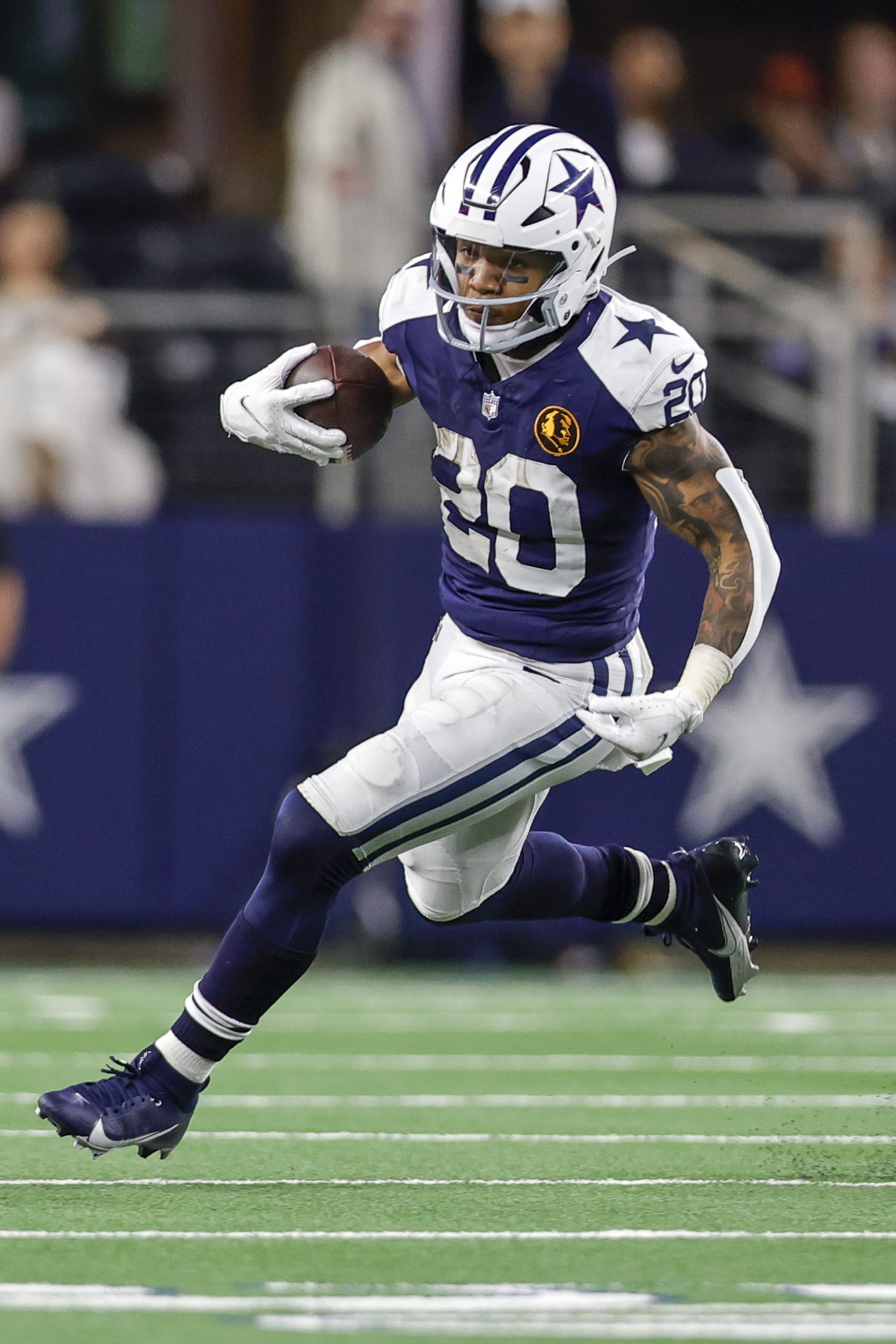ARLINGTON, TX - NOVEMBER 23: Dallas Cowboys running back Tony Pollard (20) runs for a first down during the game between the Dallas Cowboys and the Washington Commanders on November 23, 2023 at AT&T Stadium in Arlington, Texas. (Photo by Matthew Pearce/Icon Sportswire via Getty Images)