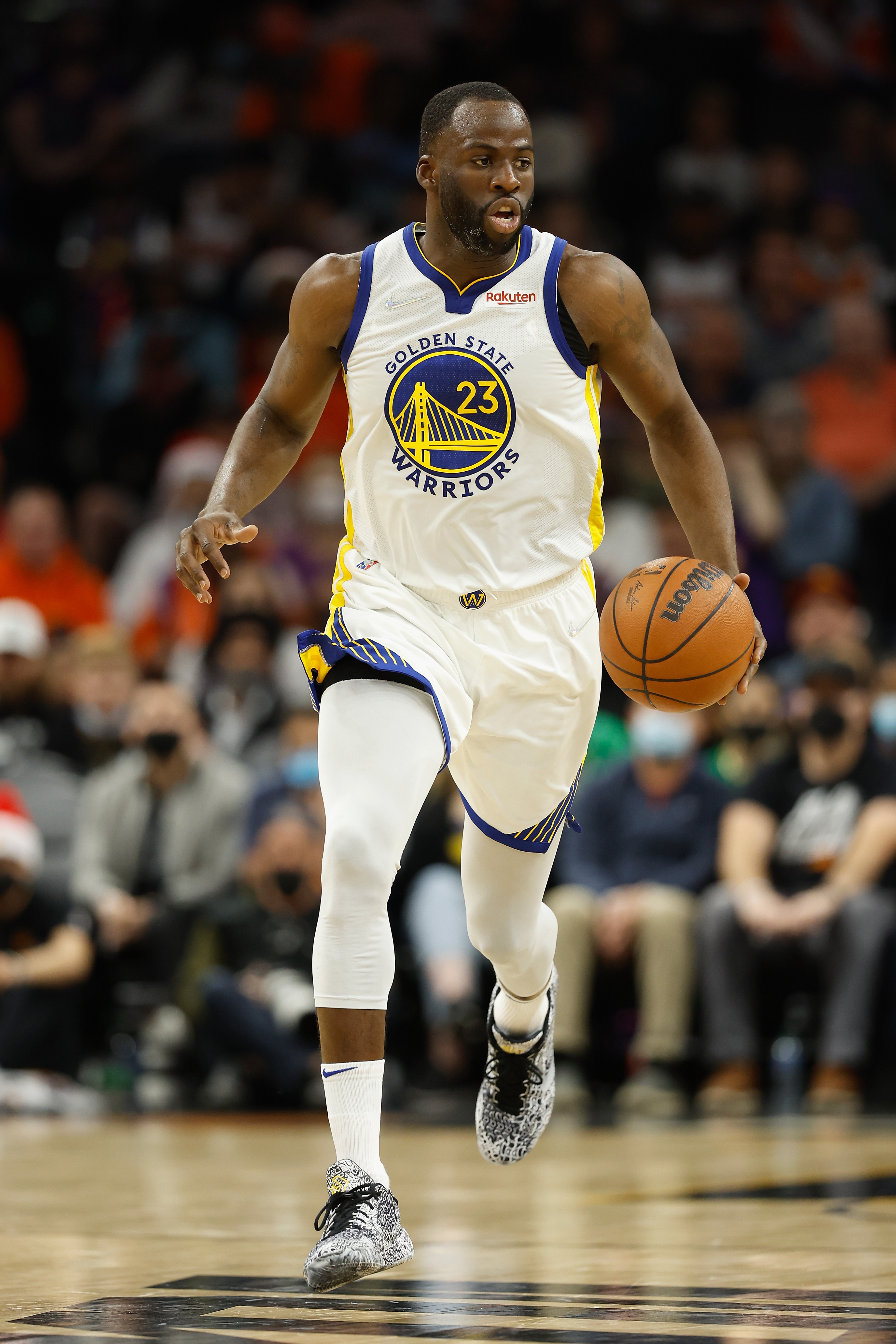 PHOENIX, ARIZONA - DECEMBER 25:  Draymond Green #23 of the Golden State Warriors handles the ball during the first half of NBA game at Footprint Center on December 25, 2021 in Phoenix, Arizona.  NOTE TO USER: User expressly acknowledges and agrees that, by downloading and or using this photograph, User is consenting to the terms and conditions of the Getty Images License Agreement.  (Photo by Christian Petersen/Getty Images)