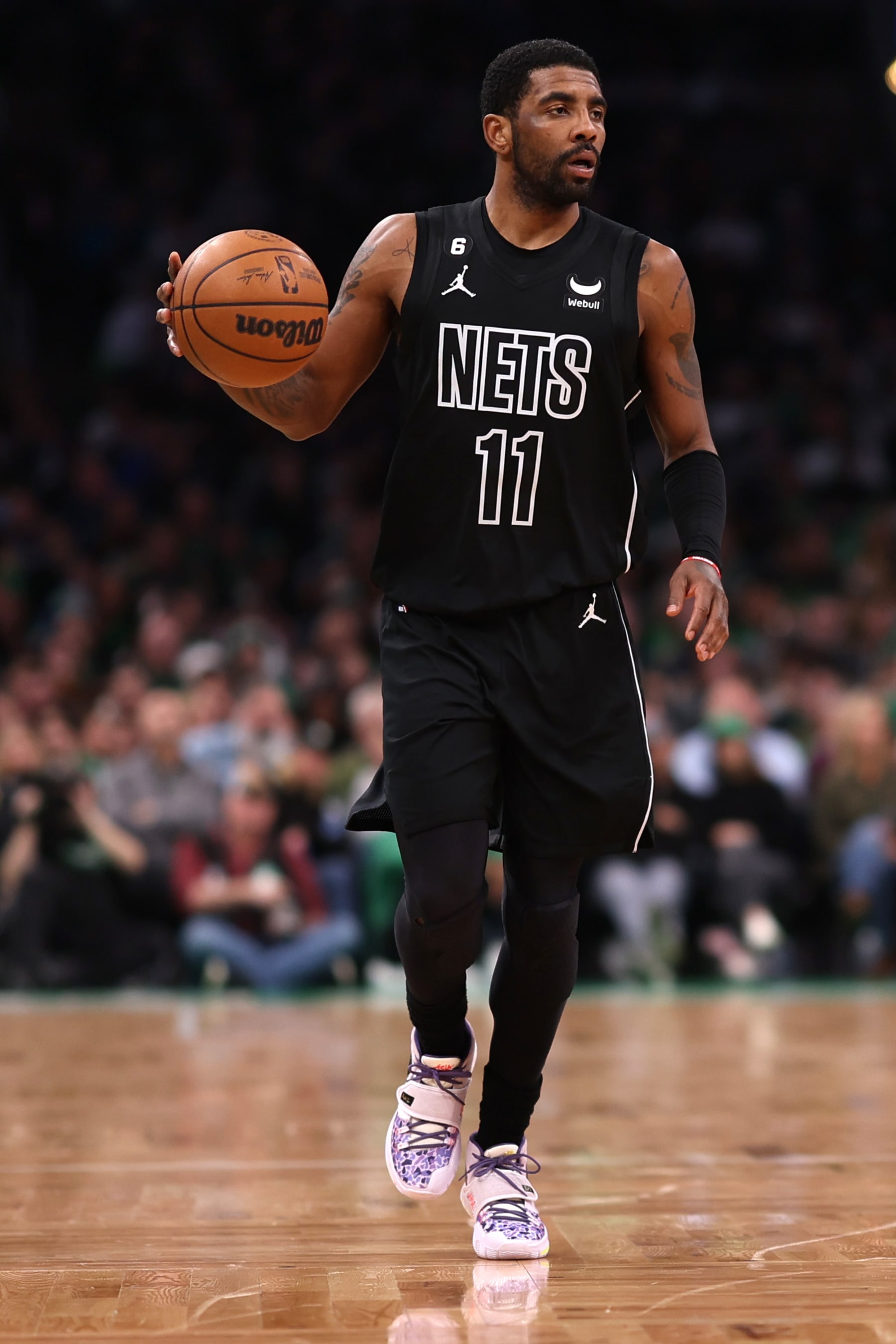 BOSTON, MASSACHUSETTS - FEBRUARY 01: Kyrie Irving #11 of the Brooklyn Nets dribbles against the Boston Celtics during the first half at TD Garden on February 01, 2023 in Boston, Massachusetts. NOTE TO USER: User expressly acknowledges and agrees that, by downloading and or using this photograph, User is consenting to the terms and conditions of the Getty Images License Agreement. (Photo by Maddie Meyer/Getty Images)