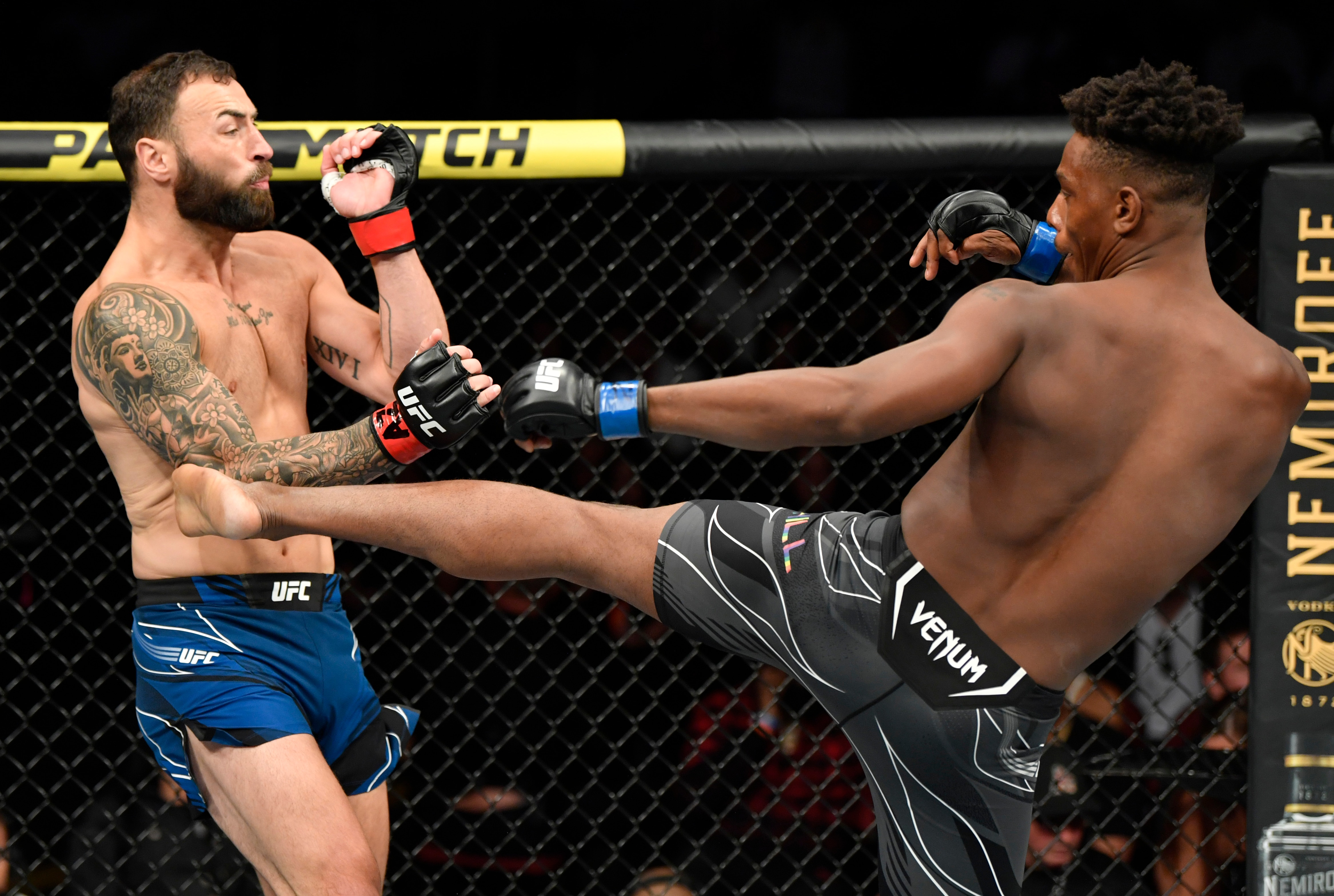 GLENDALE, ARIZONA - JUNE 12: (R-L) Jamahal Hill kicks Paul Craig of Scotland in their light heavyweight fight during the UFC 263 event at Gila River Arena on June 12, 2021 in Glendale, Arizona. (Photo by Jeff Bottari/Zuffa LLC)