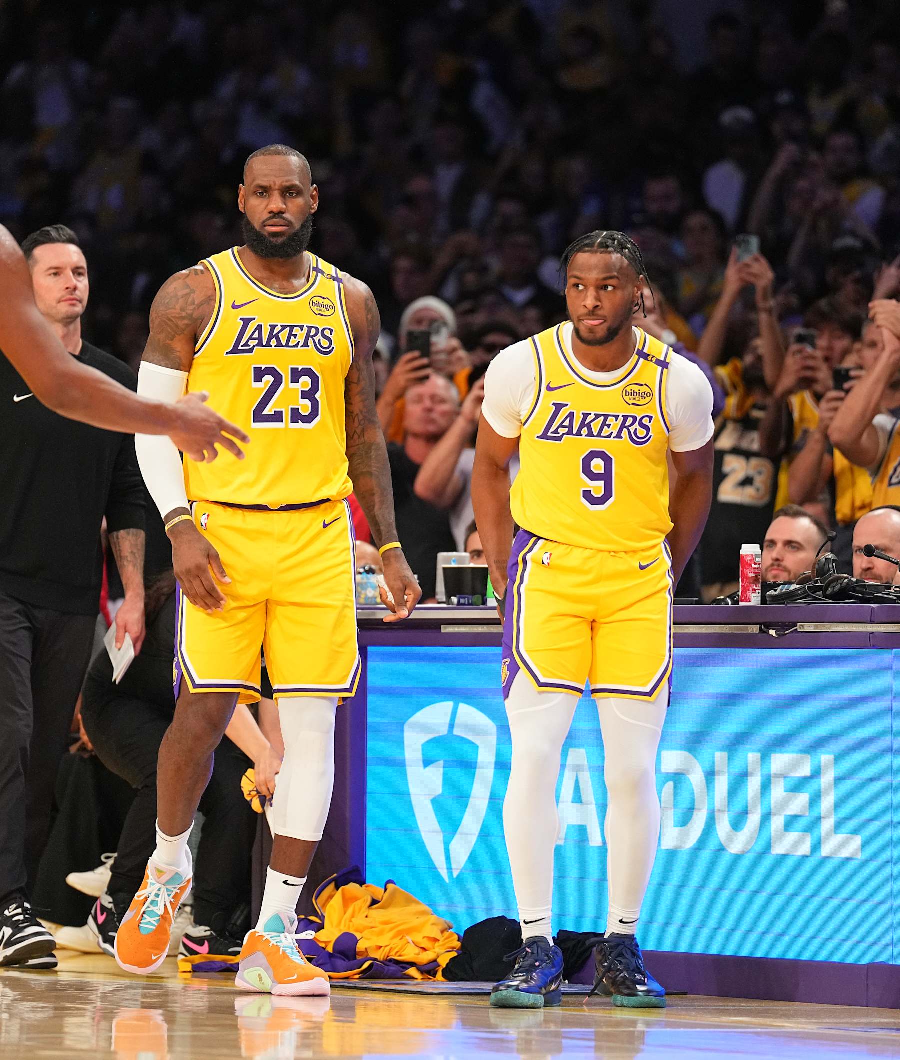 LOS ANGELES, CA - OCTOBER 22: LeBron James #23 and Bronny James #9 of the Los Angeles Lakers look on during the game against the Minnesota Timberwolves on October 22, 2024 at Crypto.Com Arena in Los Angeles, California. NOTE TO USER: User expressly acknowledges and agrees that, by downloading and/or using this Photograph, user is consenting to the terms and conditions of the Getty Images License Agreement. Mandatory Copyright Notice: Copyright 2024 NBAE (Photo by Garrett Ellwood/NBAE via Getty Images)