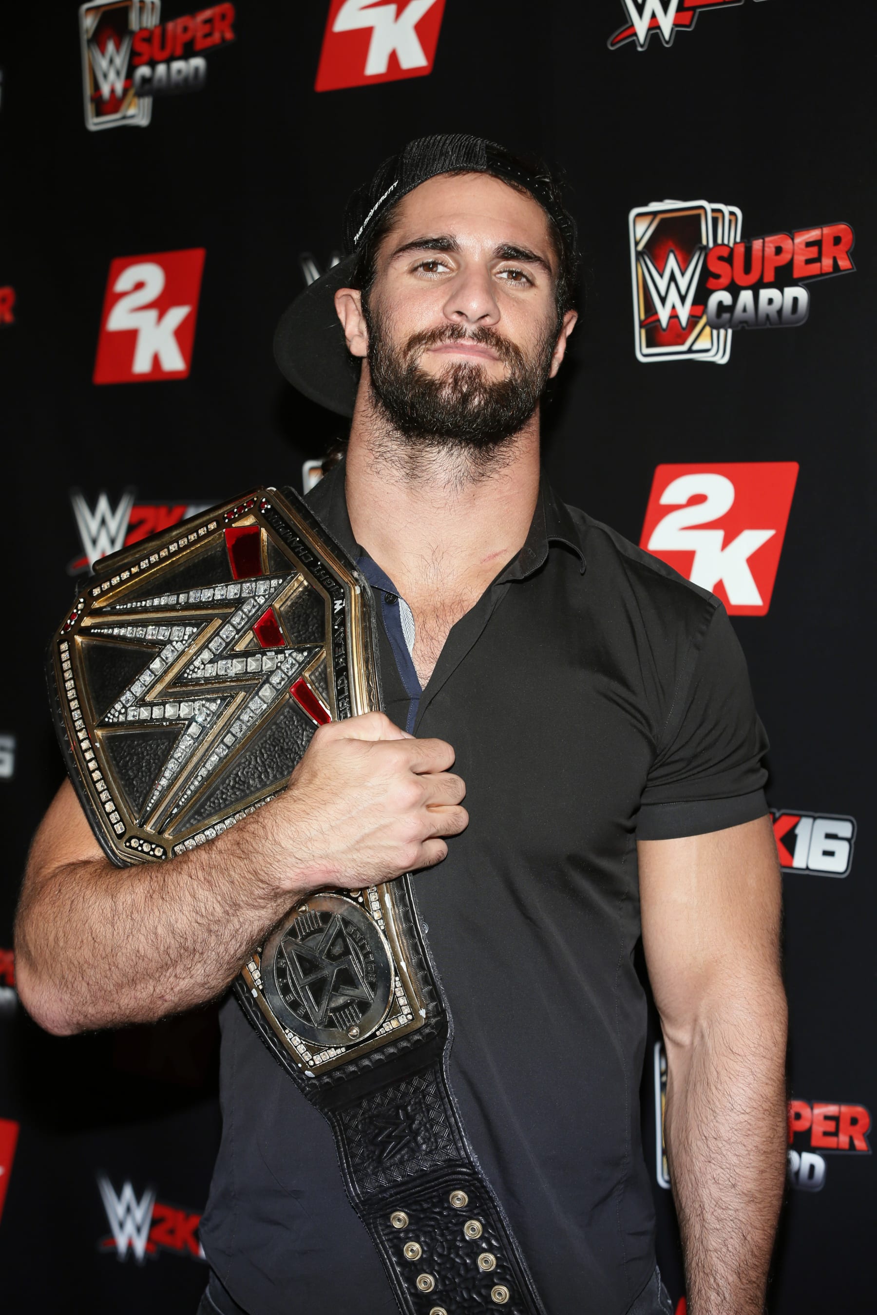 IMAGE DISTRIBUTED FOR 2K - WWE World Heavyweight Champion Seth Rollins poses with his championship title at the WWE 2K SummerSlam Kickoff in New York, N.Y., on Thursday, Aug. 20, 2015. (Photo by Stuart Ramson/Invision for 2K/AP Images)