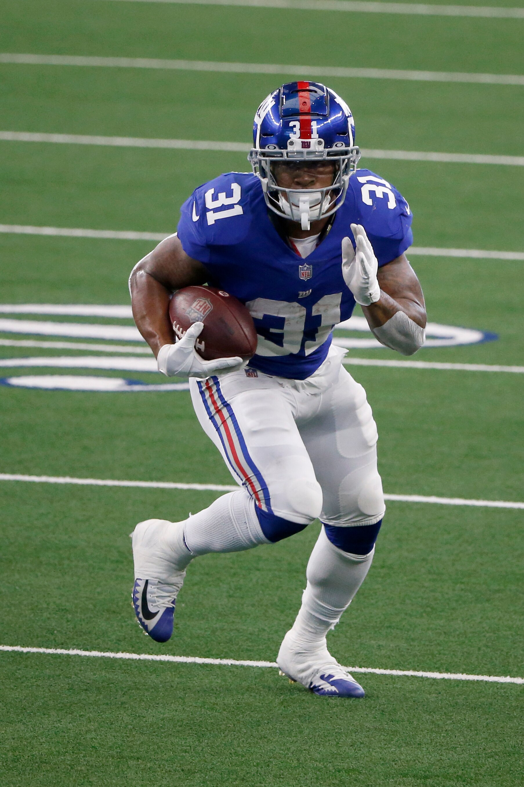 New York Giants running back Devonta Freeman (31) runs against the Dallas Cowboys during the first half of an NFL Football game in Arlington, Texas, Sunday, Oct. 11, 2020. (AP Photo/Michael Ainsworth)