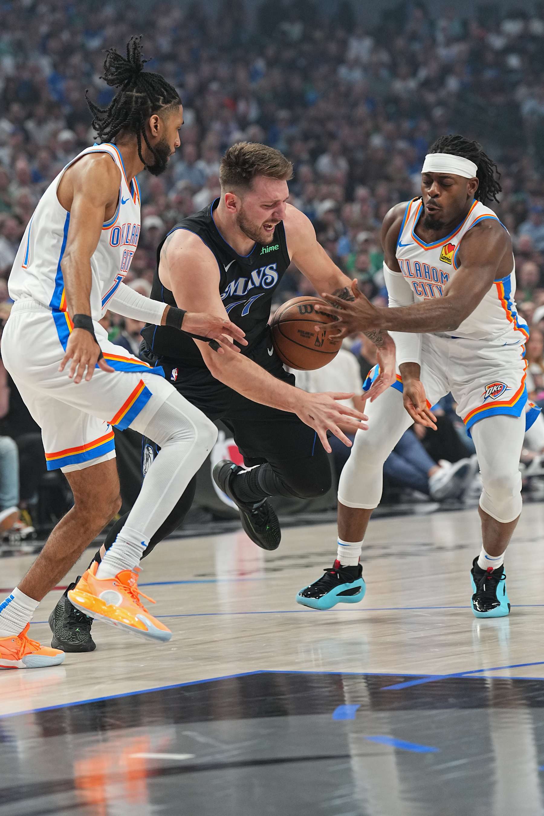 DALLAS, TX - MAY 18: Luguentz Dort #5 of the Oklahoma City Thunder steals the ball from Luka Doncic #77 of the Dallas Mavericks during the game during Round 2 Game 6 of the 2024 NBA Playoffs  on May 18, 2024  at the American Airlines Center in Dallas, Texas. NOTE TO USER: User expressly acknowledges and agrees that, by downloading and or using this photograph, User is consenting to the terms and conditions of the Getty Images License Agreement. Mandatory Copyright Notice: Copyright 2024 NBAE (Photo by Glenn James/NBAE via Getty Images)