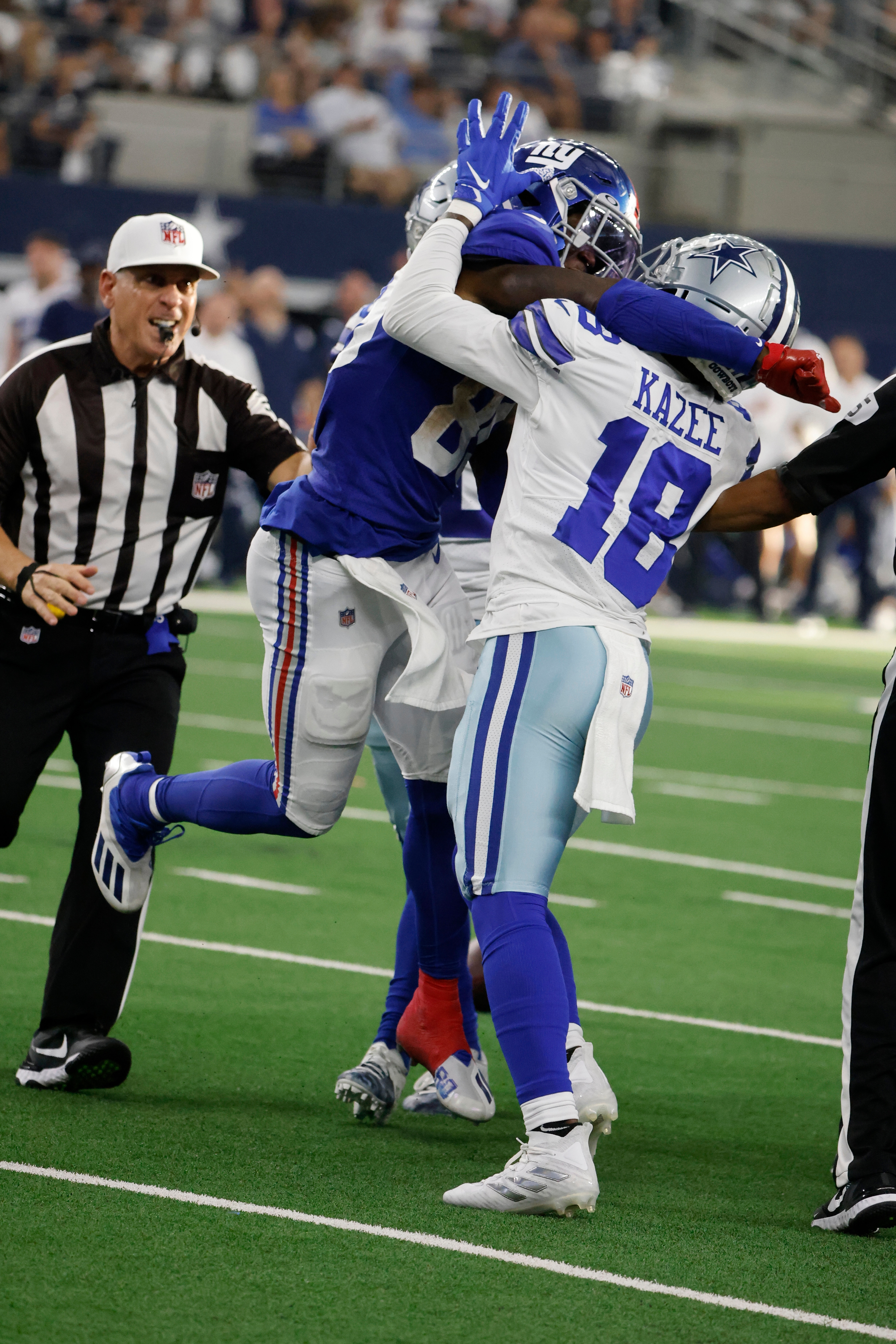 New York Giants wide receiver Kadarius Toney (89) throws a punch at Dallas Cowboys safety Damontae Kazee (18) in the second half of an NFL football game in Arlington, Texas, Sunday, Oct. 10, 2021. (AP Photo/Michael Ainsworth)