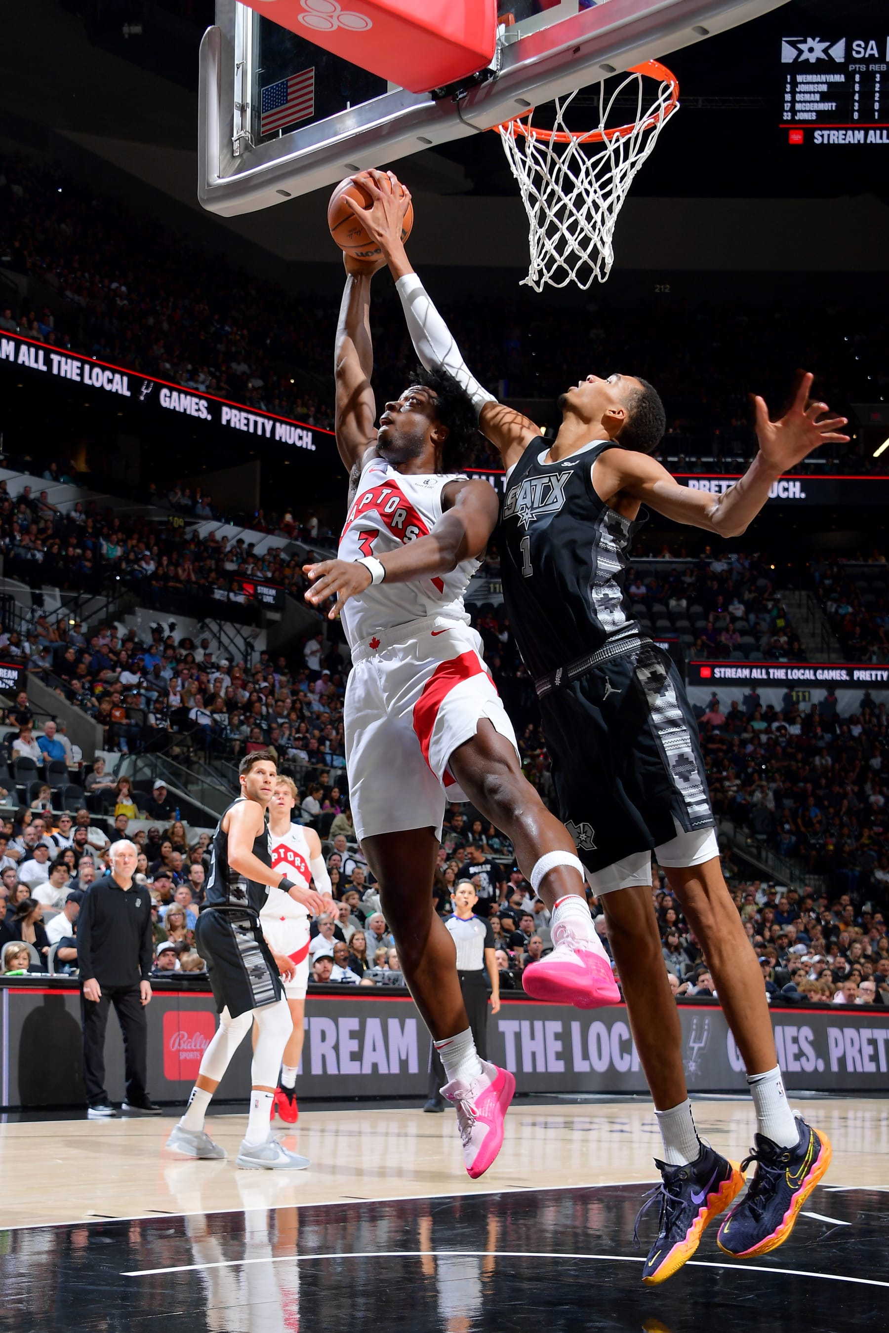 SAN ANTONIO, TX - NOVEMBER 5: OG Anunoby #3 of the Toronto Raptors drives to the basket while Victor Wembanyama #1 of the San Antonio Spurs goes for the block during the game on November 5, 2023 at the Frost Bank Center in San Antonio, Texas. NOTE TO USER: User expressly acknowledges and agrees that, by downloading and or using this photograph, user is consenting to the terms and conditions of the Getty Images License Agreement. Mandatory Copyright Notice: Copyright 2023 NBAE (Photos by Michael Gonzales/NBAE via Getty Images)