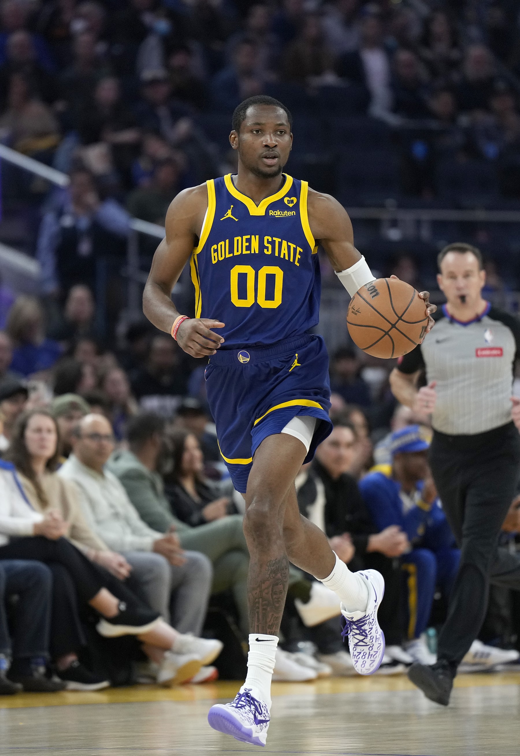 SAN FRANCISCO, CALIFORNIA - FEBRUARY 23: Jonathan Kuminga #00 of the Golden State Warriors dribbles the ball up court against the Charlotte Hornets during the first quarter of an NBA basketball game at Chase Center on February 23, 2024 in San Francisco, California. NOTE TO USER: User expressly acknowledges and agrees that, by downloading and or using this photograph, User is consenting to the terms and conditions of the Getty Images License Agreement. (Photo by Thearon W. Henderson/Getty Images)