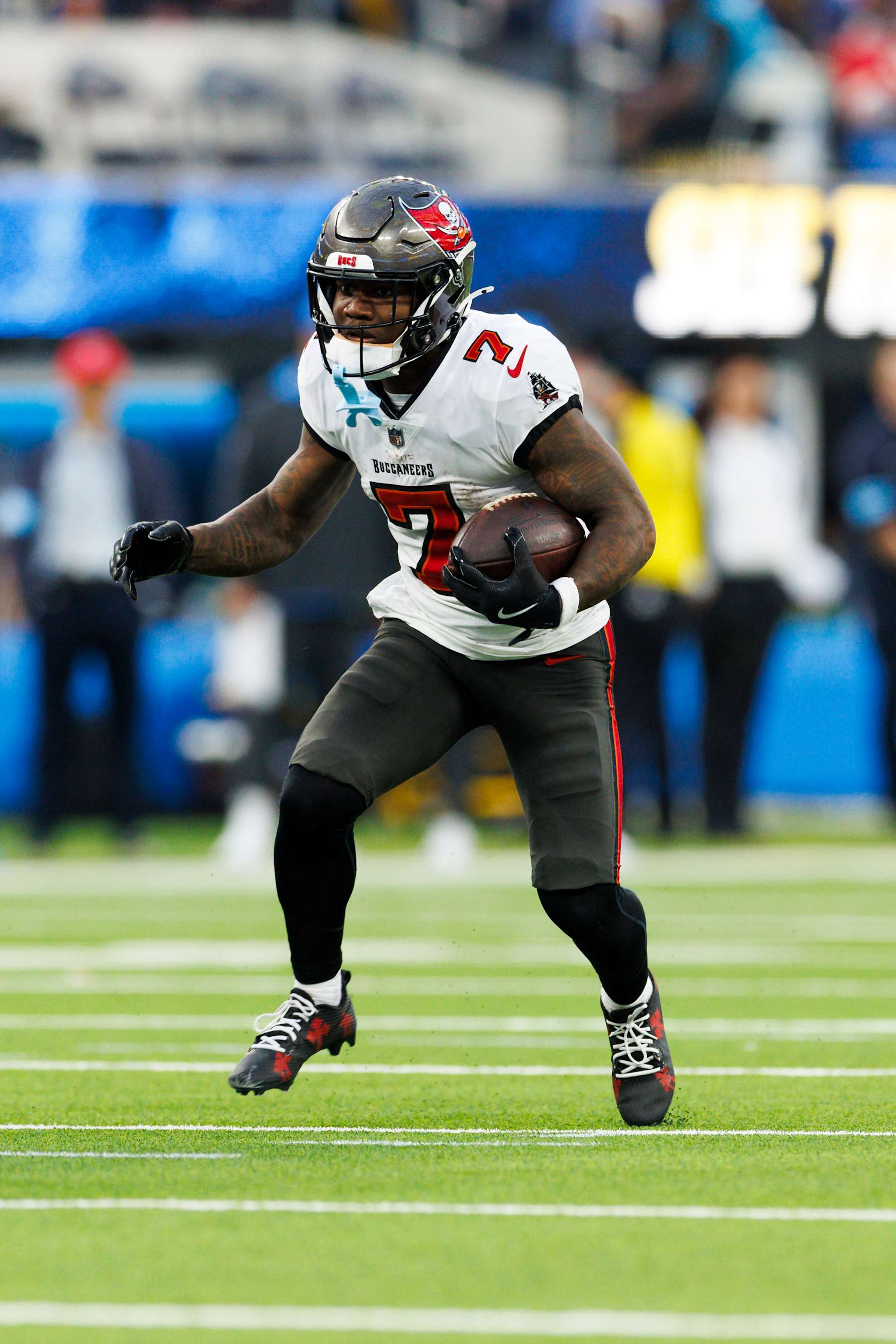 INGLEWOOD, CALIFORNIA - DECEMBER 15: Bucky Irving #7 of the Tampa Bay Buccaneers runs with the ball during the second half against the Los Angeles Chargers at SoFi Stadium on December 15, 2024 in Inglewood, California. (Photo by Ric Tapia/Getty Images)