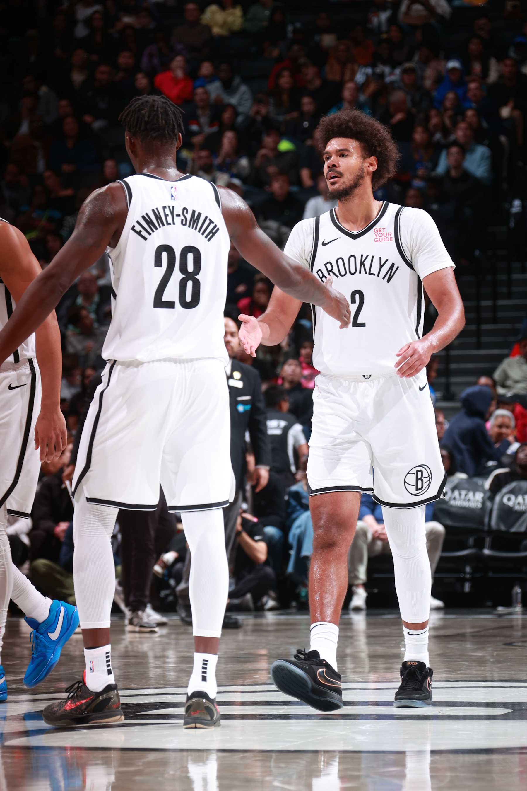 BROOKLYN, NY - OCTOBER 14: Dorian Finney-Smith #28 and Cameron Johnson #2 of the Brooklyn Nets high five during the game against the Washington Wizards during a NBA preseason game on October 14, 2024 at Barclays Center in Brooklyn, New York. NOTE TO USER: User expressly acknowledges and agrees that, by downloading and or using this Photograph, user is consenting to the terms and conditions of the Getty Images License Agreement. Mandatory Copyright Notice: Copyright 2024 NBAE (Photo by Nathaniel S. Butler/NBAE via Getty Images)