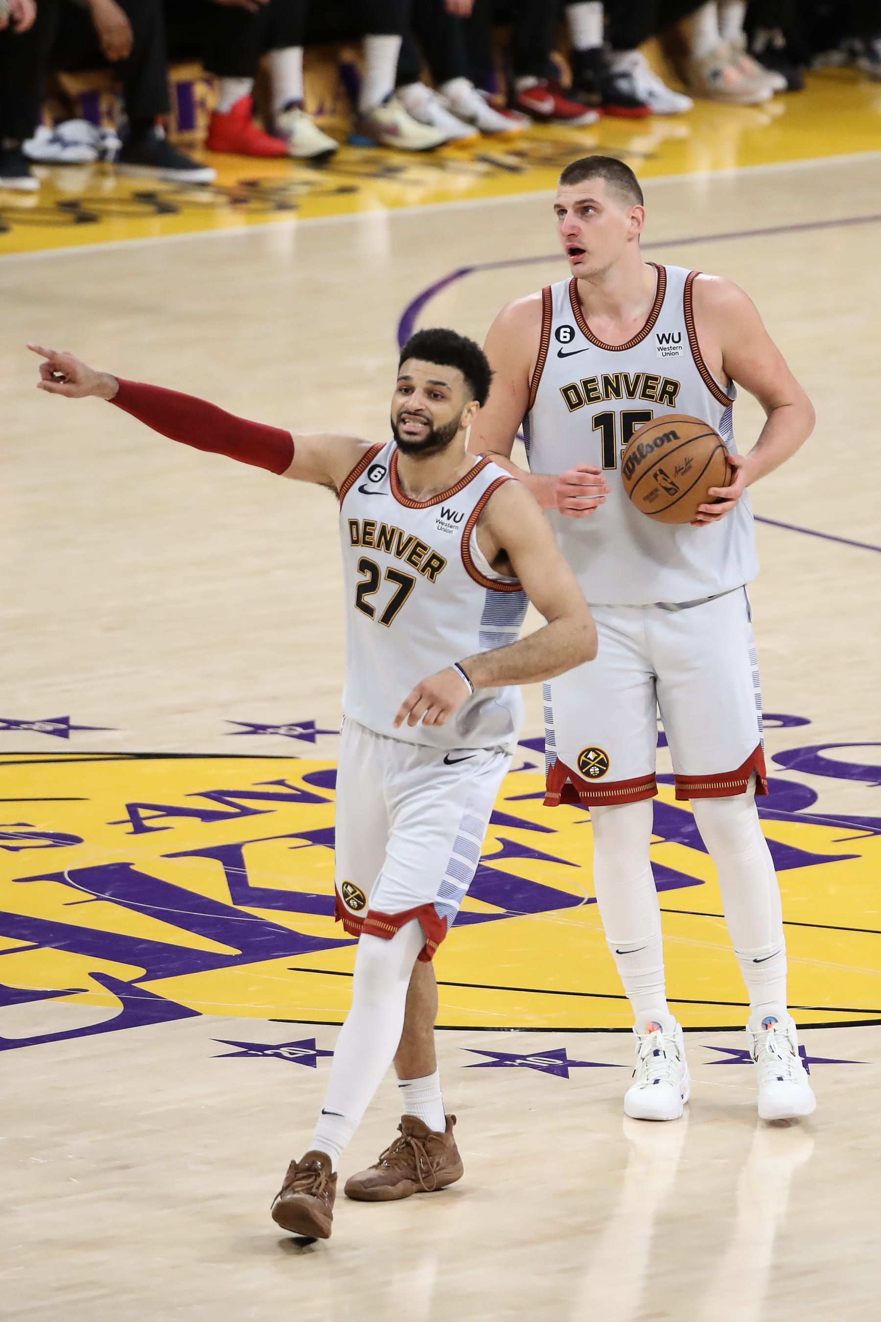 LOS ANGELES, CA - MAY 22: Denver Nuggets guard Jamal Murray (27) points while Denver Nuggets center Nikola Jokic (15) has the ball during the Denver Nuggets versus the Los Angeles Lakers in Game 4 of the NBA Western Conference Finals on May 22, 2023, at Crypto.com Arena in Los Angeles, CA. (Photo by Jevone Moore/Icon Sportswire via Getty Images)