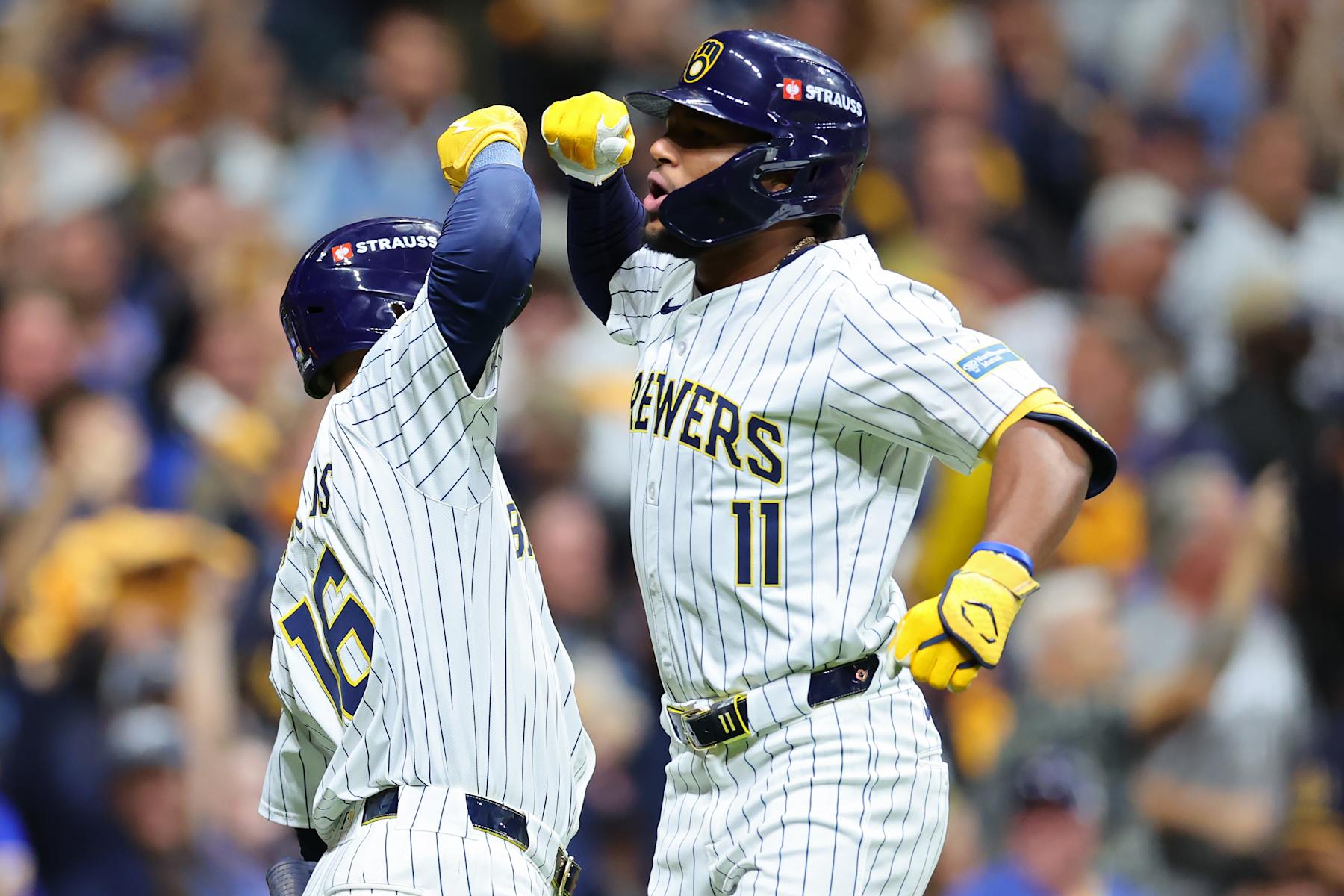 MILWAUKEE, WISCONSIN - OCTOBER 02: Blake Perkins #16 and Jackson Chourio #11 of the Milwaukee Brewers celebrate after Chourio hit a home run in the eighth inning against the New York Mets during Game Two of the Wild Card Series at American Family Field on October 02, 2024 in Milwaukee, Wisconsin.  (Photo by Stacy Revere/Getty Images)