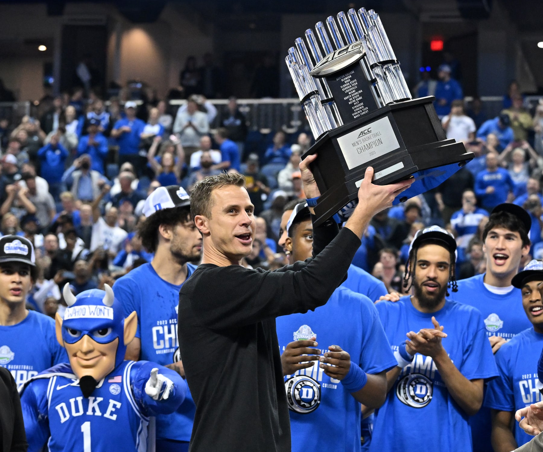 GREENSBORO, NORTH CAROLINA - MARCH 11: Head coach Jon Scheyer and the Duke Blue Devils hoist the trophy after a win against the Virginia Cavaliers in the ACC Basketball Tournament Championship game at Greensboro Coliseum on March 11, 2023 in Greensboro, North Carolina. Duke won 59-49. (Photo by Grant Halverson/Getty Images)