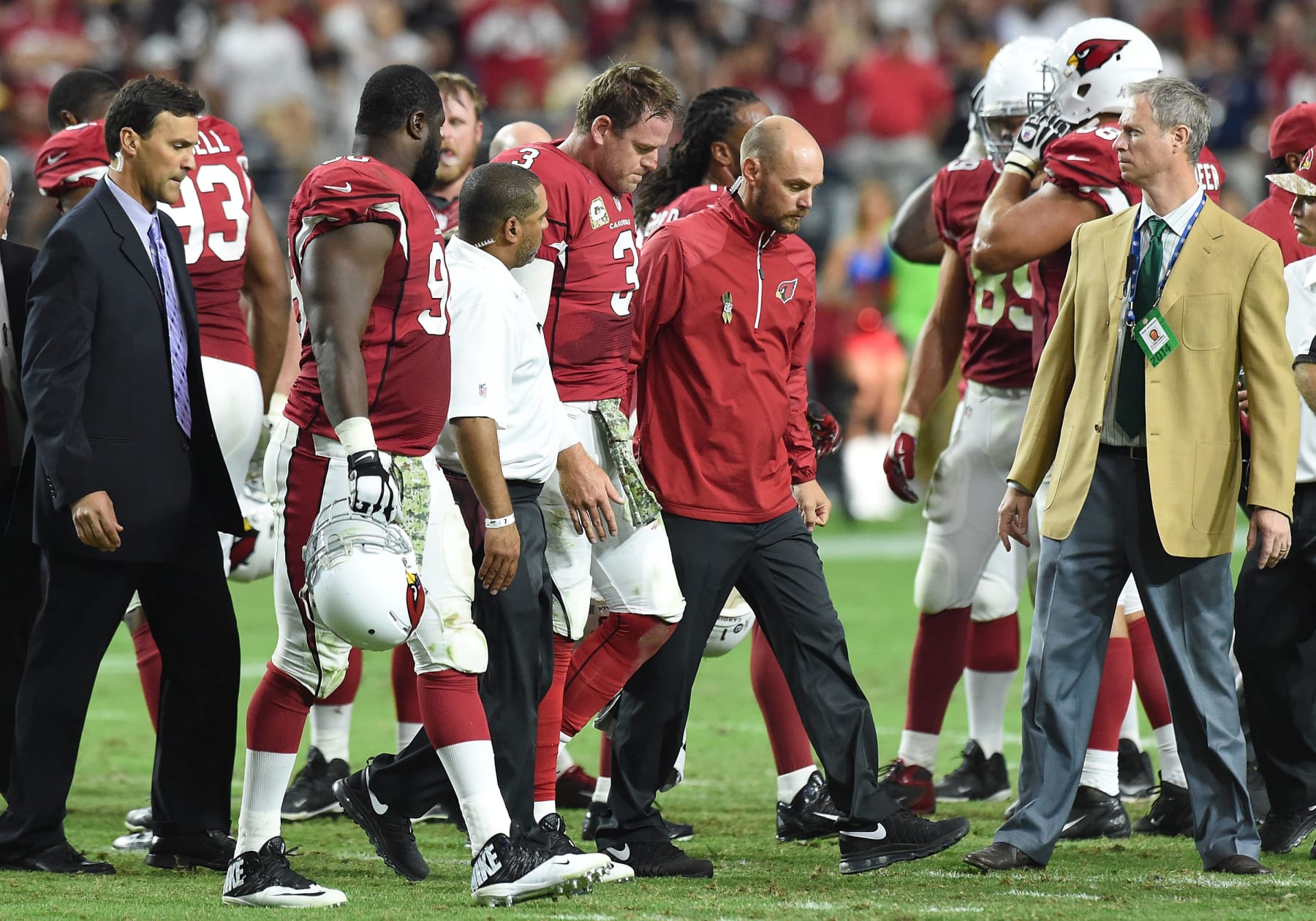 GLENDALE, AZ - NOVEMBER 09: Quarterback Carson Palmer #3 of the Arizona Cardinals is escorted off the field by training staff after being injured in the third quarter of the NFL game against the St. Louis Rams at University of Phoenix Stadium on November 9, 2014 in Glendale, Arizona. (Photo by Norm Hall/Getty Images)