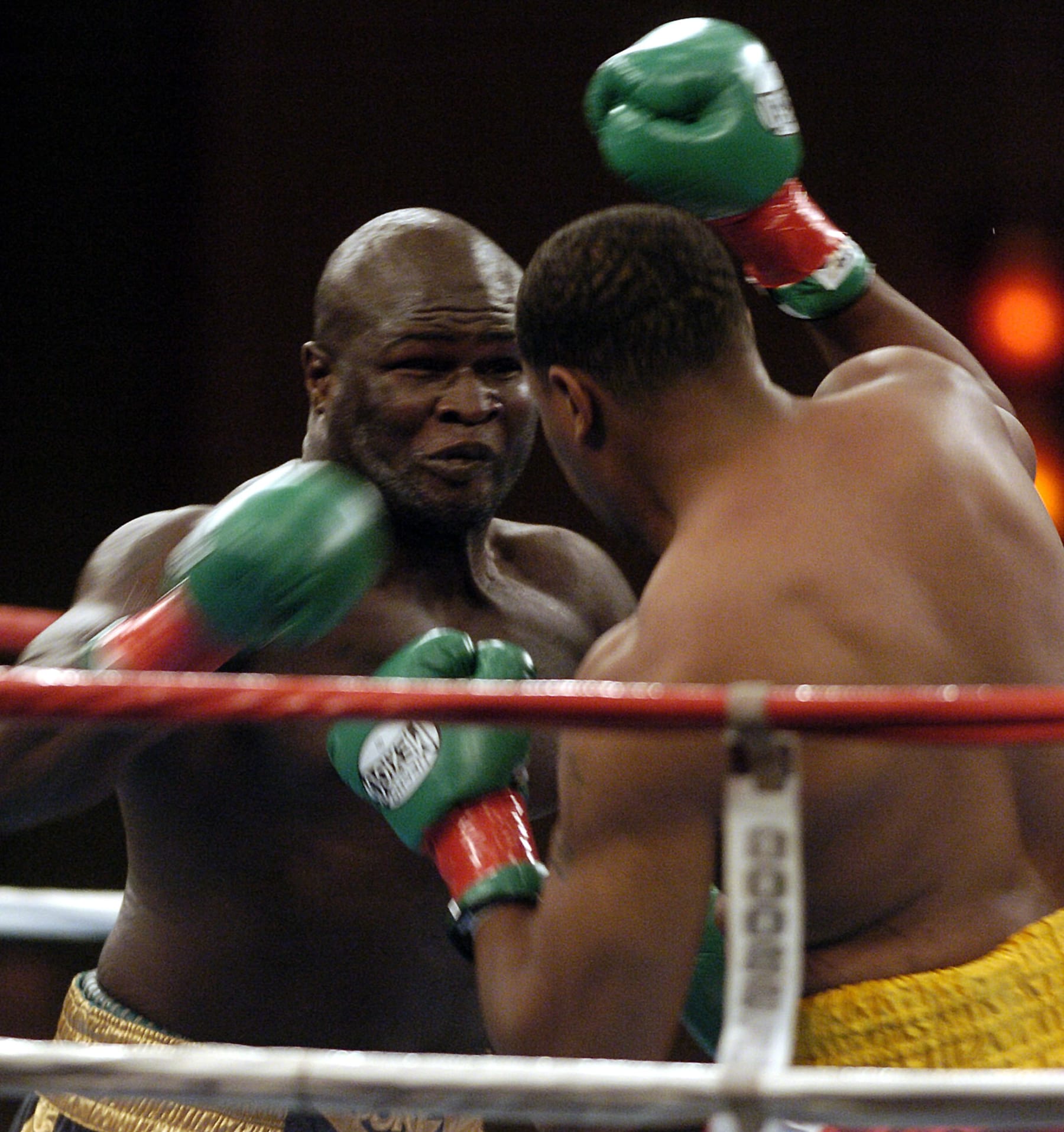James Toney, left, fires a punch on Rydell Booker, right, during the first round of their WBC and IBA Heavyweight Championship Bout held at Pechanga Resort and Casino in Temecula, Calif. Thursday, Sept. 23, 2004. (AP Photo/Denis Poroy)