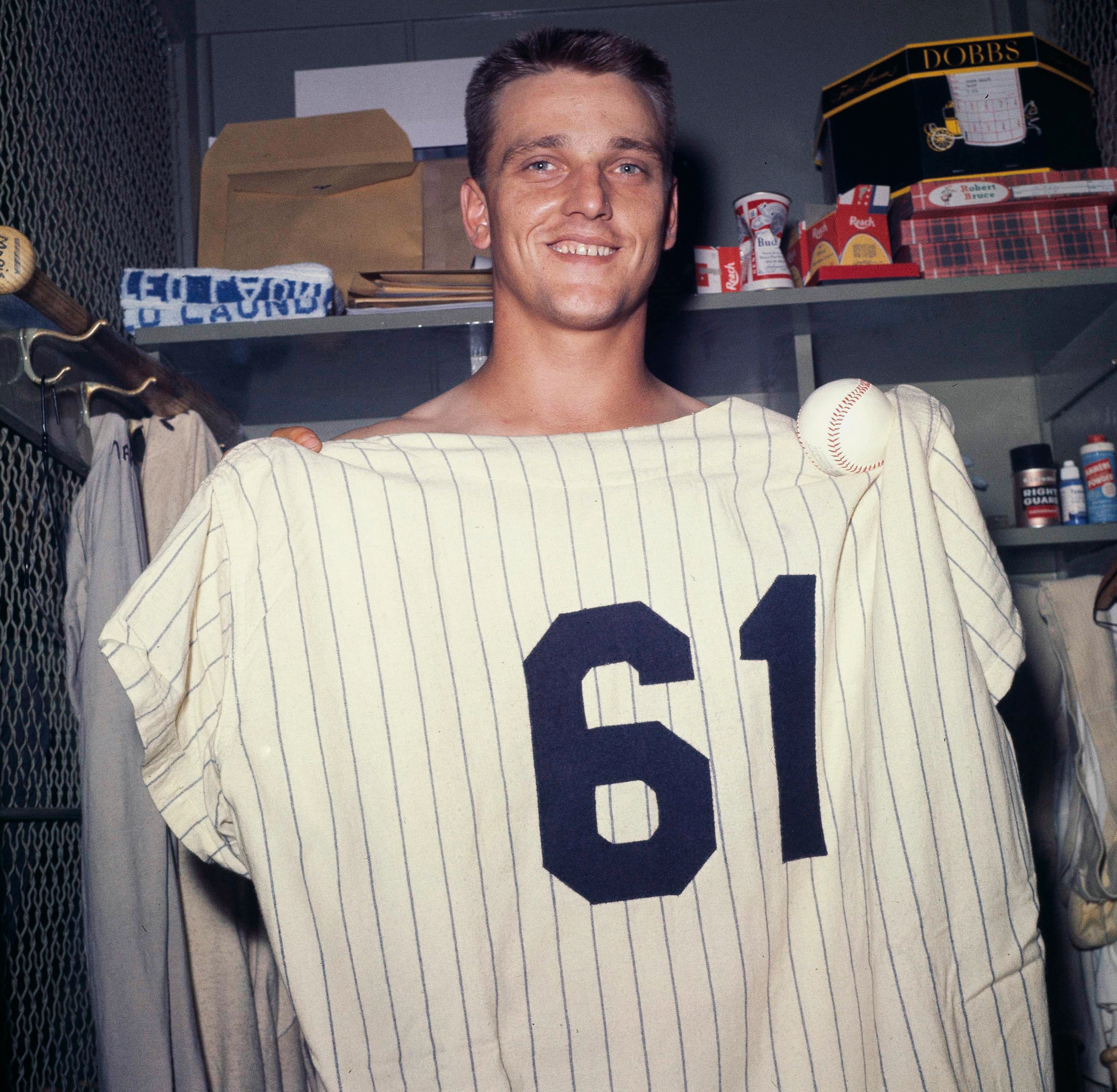 New York Yankees slugger Roger Maris poses at Yankee Stadium on the final day of the regulars season, Oct. 1, 1961, with a jersey indicating he hit his 61st home run, breaking Babe Ruth's single-season record. (AP Photo)