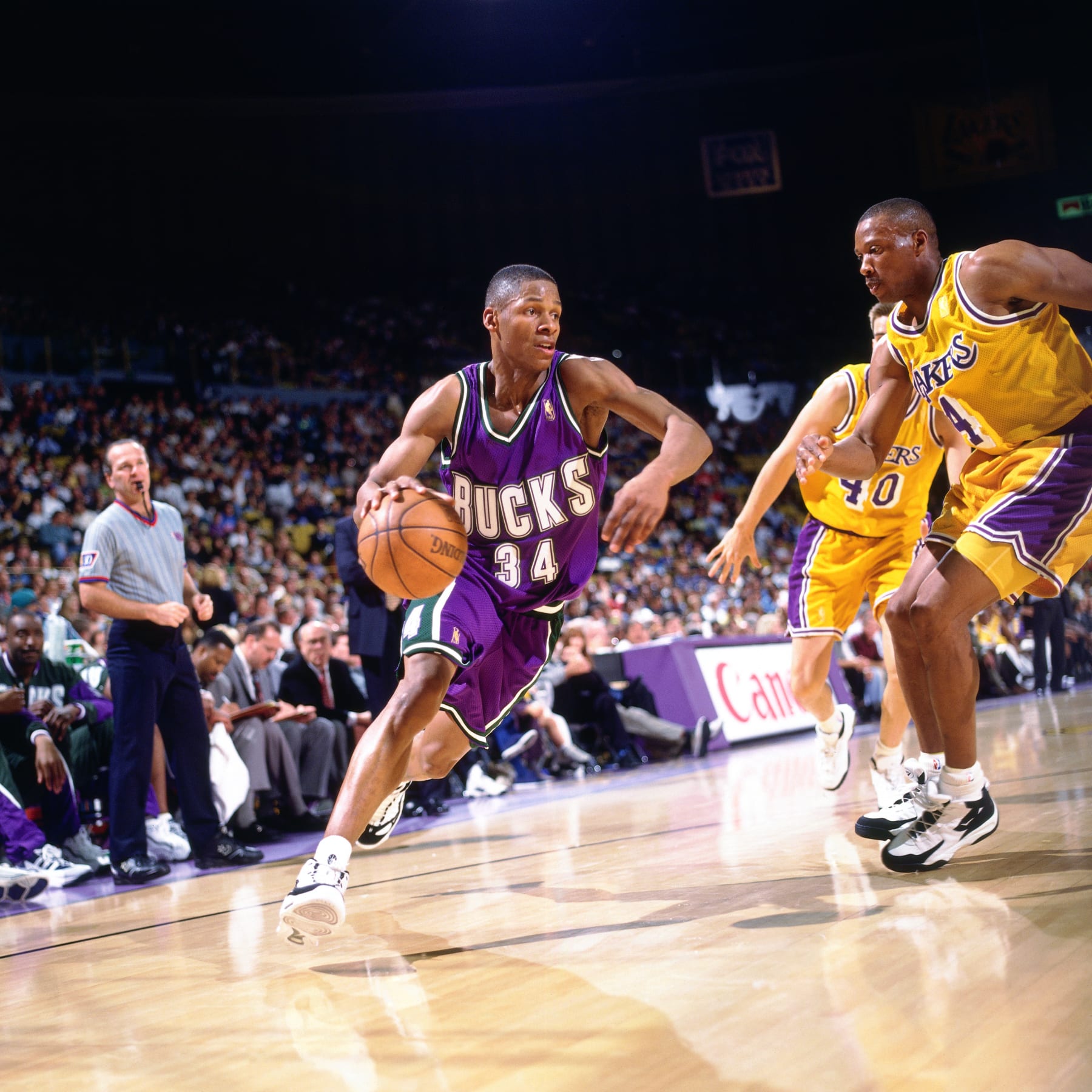 INGLEWOOD, CA - 1998: Ray Allen #34 of the Milwaukee Bucks drives to the basket against Byron Scott #4 of the Los Angeles Lakers circa 1997 at the Great Western Forum in Inglewood, California. NOTE TO USER: User expressly acknowledges and agrees that, by downloading and or using this photograph, User is consenting to the terms and conditions of the Getty Images License Agreement. Mandatory Copyright Notice: Copyright 1998 NBAE (Photo by Jon Soohoo/NBAE via Getty Images)  Earvin "Magic" Johnson;Kareem Abdul-Jabbar