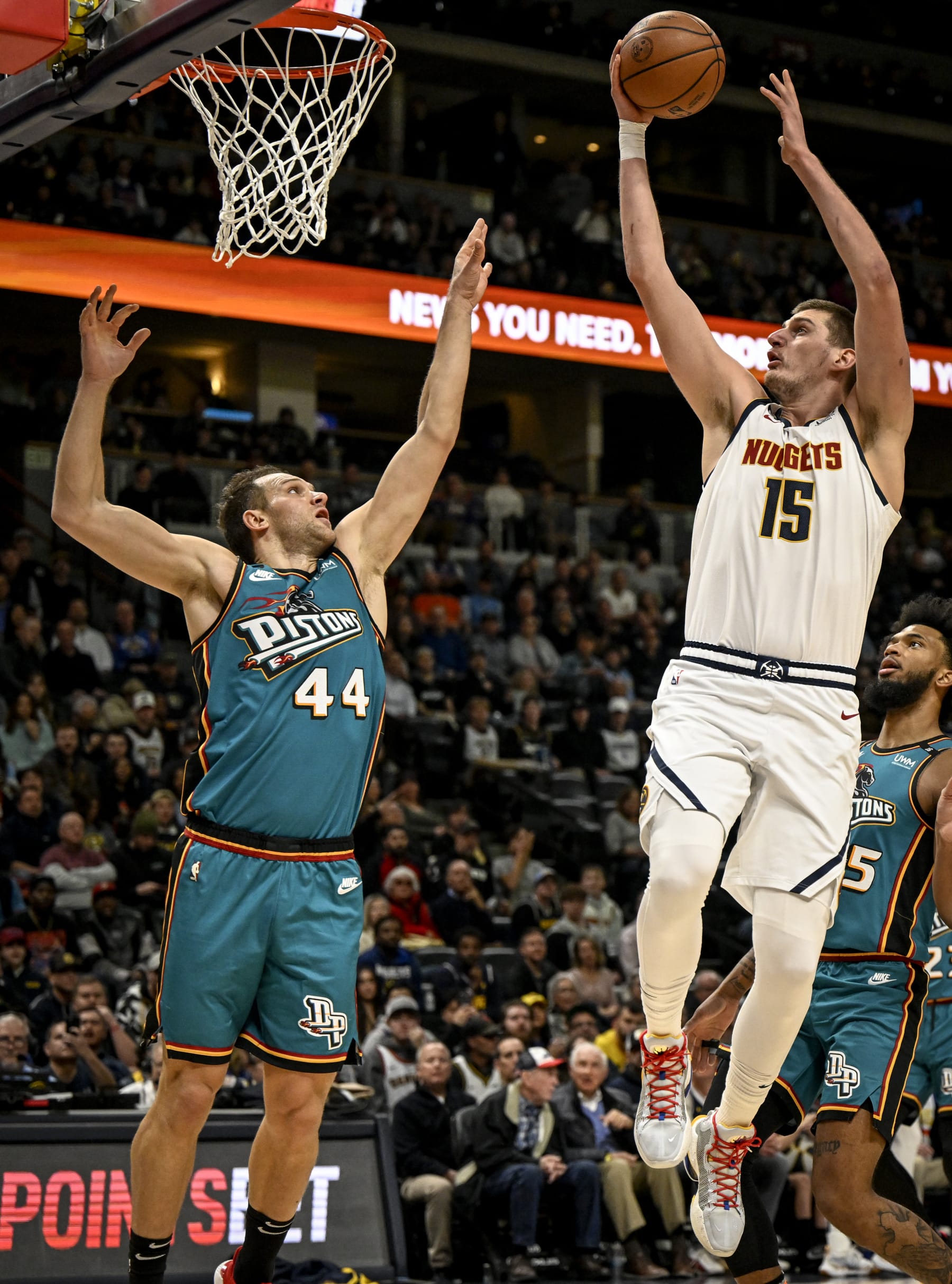 DENVER, CO - NOVEMBER 22: Nikola Jokic (15) of the Denver Nuggets finishes over Bojan Bogdanovic (44) of the Detroit Pistons during the first quarter at Ball Arena in Denver on Tuesday, November 22, 2022. (Photo by AAron Ontiveroz/MediaNews Group/The Denver Post via Getty Images)