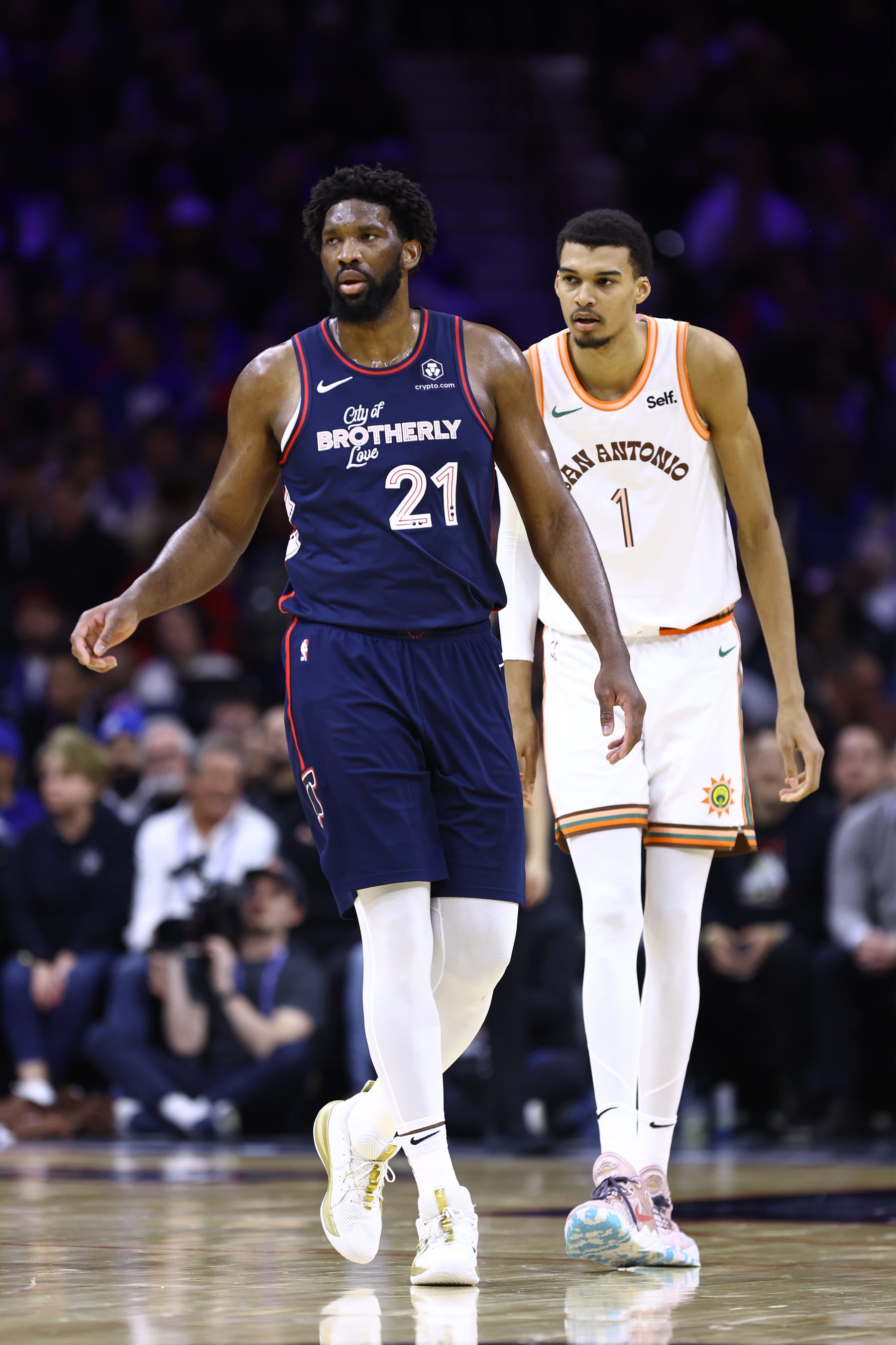 PHILADELPHIA, PENNSYLVANIA - JANUARY 22: Joel Embiid #21 of the Philadelphia 76ers and Victor Wembanyama #1 of the San Antonio Spurs look on during the second quarter at the Wells Fargo Center on January 22, 2024 in Philadelphia, Pennsylvania. NOTE TO USER: User expressly acknowledges and agrees that, by downloading and or using this photograph, User is consenting to the terms and conditions of the Getty Images License Agreement. (Photo by Tim Nwachukwu/Getty Images)