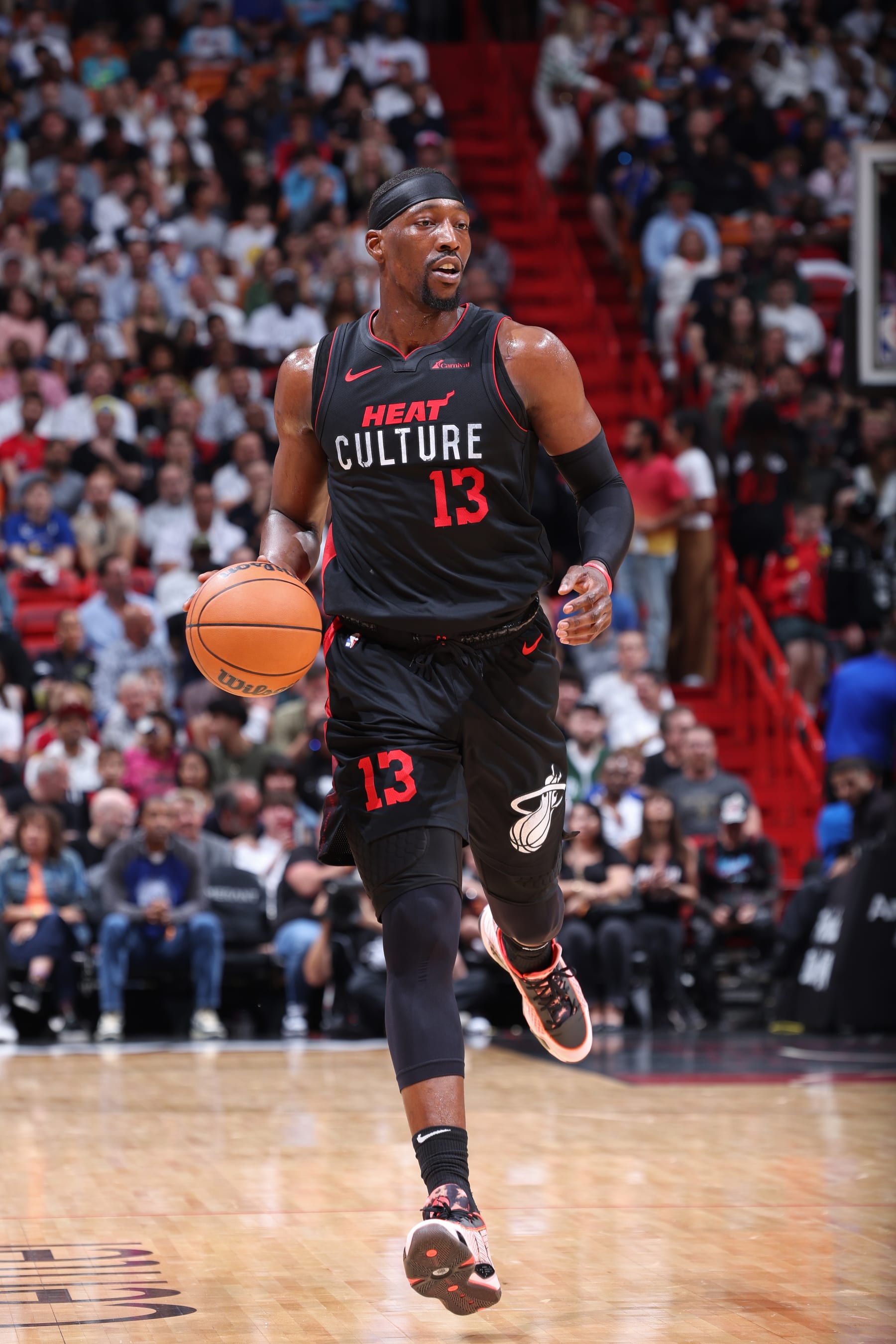 MIAMI, FL - MARCH 26:  Bam Adebayo #13 of the Miami Heat dribbles the ball during the game against the Golden State Warriors on March 26, 2024 at Kaseya Center in Miami, Florida. NOTE TO USER: User expressly acknowledges and agrees that, by downloading and or using this Photograph, user is consenting to the terms and conditions of the Getty Images License Agreement. Mandatory Copyright Notice: Copyright 2024 NBAE (Photo by Jeff Haynes/NBAE via Getty Images)