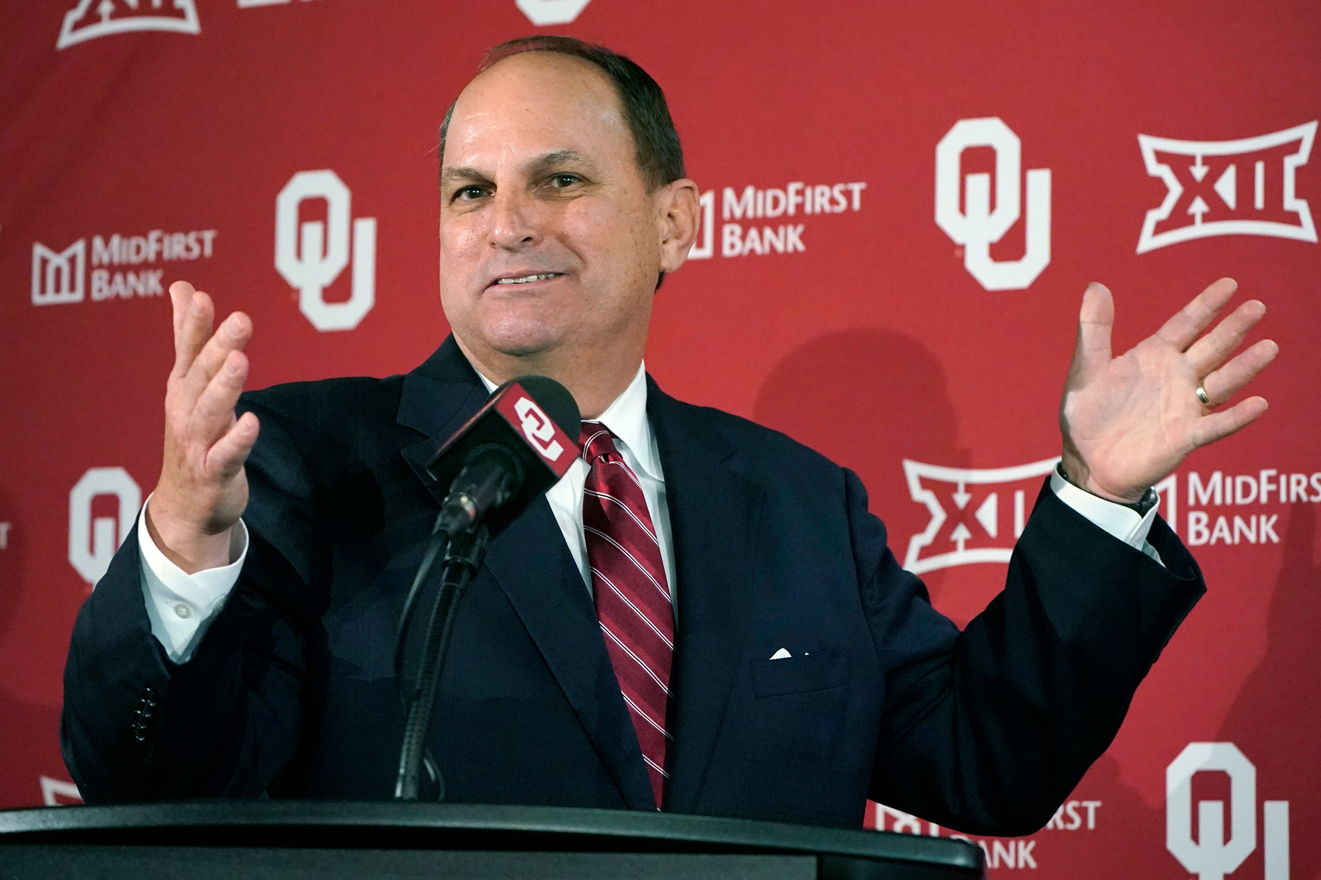 Oklahoma Athletics Director Joe Castiglione gestures as he speaks during an NCAA college football news conference, Monday, Nov. 29, 2021, in Norman, Okla to announce that Bob Stoops, formerly the Oklahoma head coach, will step in as interim head coach for the team's bowl game. (AP Photo/Sue Ogrocki)