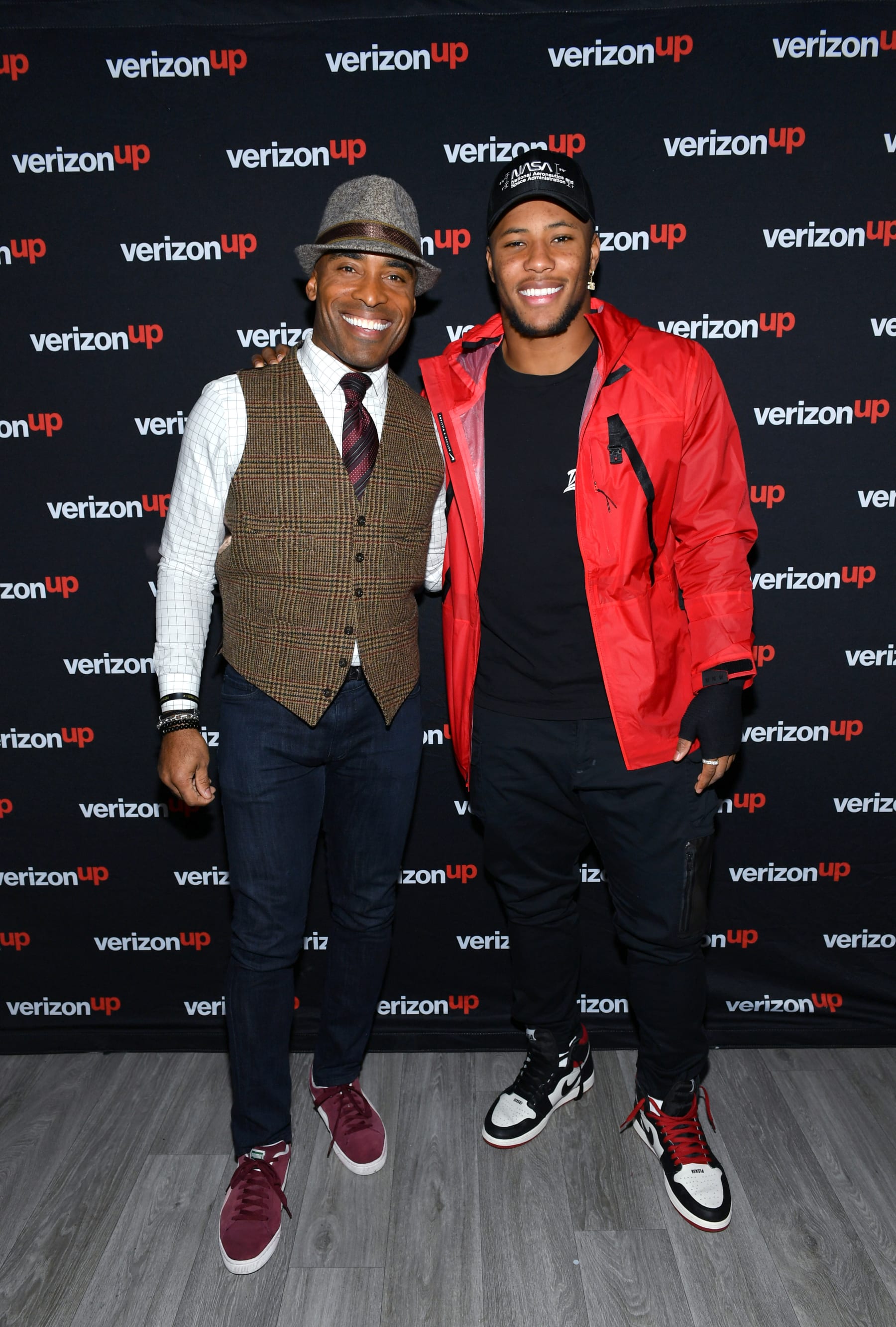 NEW YORK, NEW YORK - DECEMBER 18: Saquon Barkley (R)  hosts event for lucky Verizon Up Super Ticket recipients together with Tiki Barber at Bryant Park on December 18, 2019 in New York City. (Photo by Mike Coppola/Getty Images for Verizon)