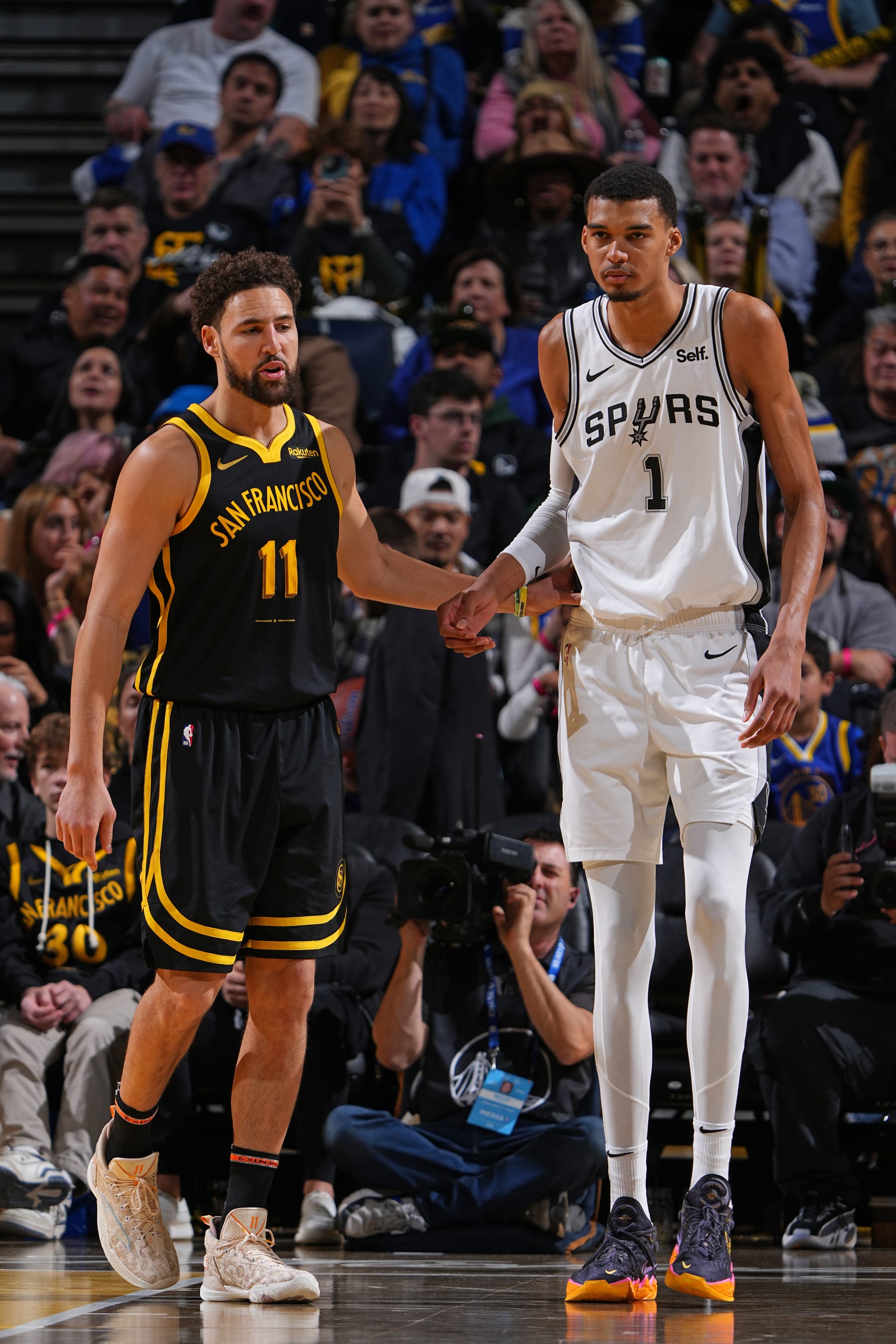 SAN FRANCISCO, CA - NOVEMBER 24:  Klay Thompson #11 of the Golden State Warriors & Victor Wembanyama #1 of the San Antonio Spurs looks on during the game during the In-Season Tournament on November 24, 2023 at Chase Center in San Francisco, California. NOTE TO USER: User expressly acknowledges and agrees that, by downloading and or using this photograph, user is consenting to the terms and conditions of Getty Images License Agreement. Mandatory Copyright Notice: Copyright 2023 NBAE (Photo by Garrett Ellwood/NBAE via Getty Images)
