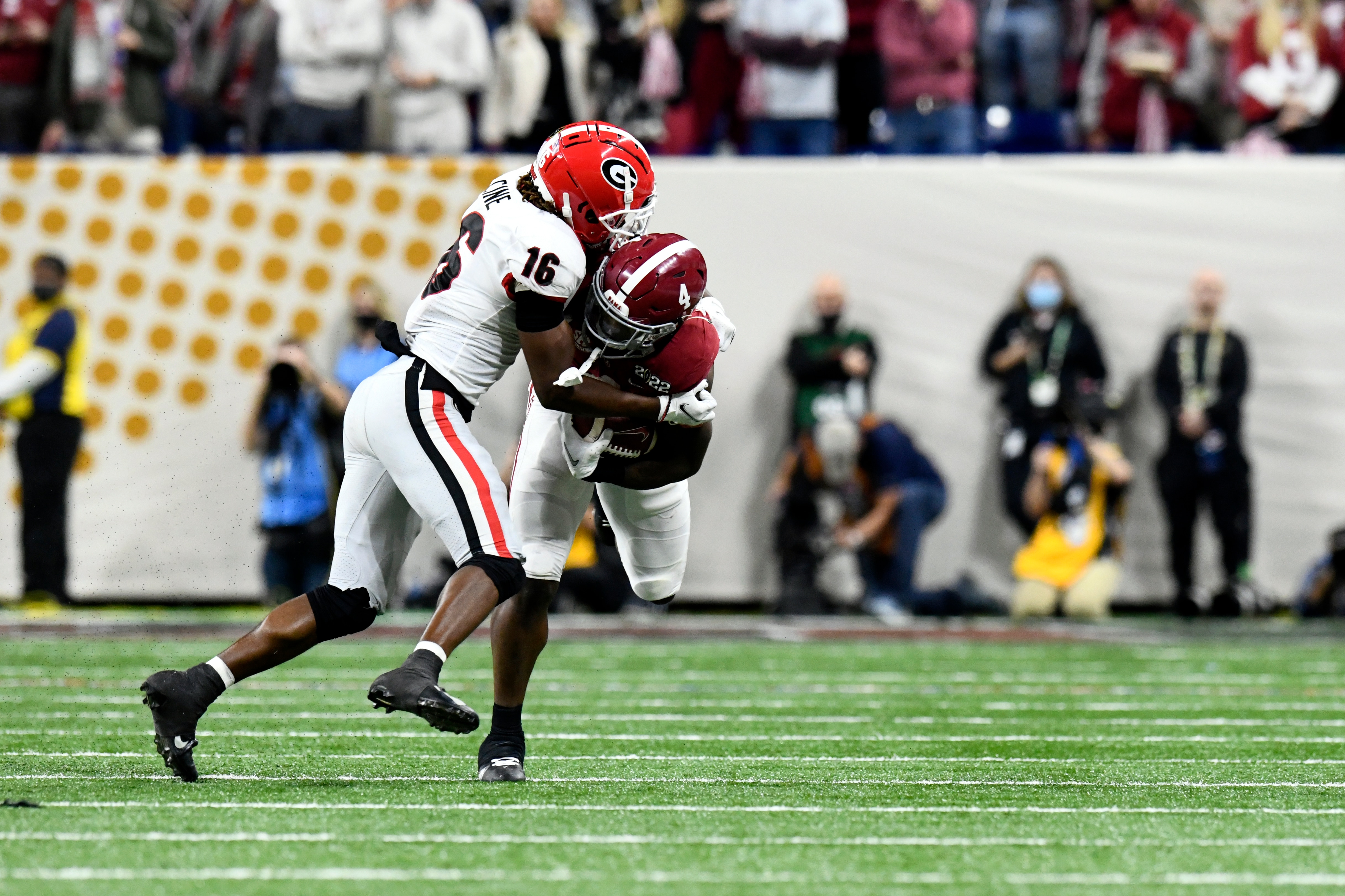 INDIANAPOLIS, IN - JANUARY 10: Alabama Crimson Tide RB Brian Robinson Jr. (4) is hit by Georgia Bulldogs DB Lewis Cine (16) during the Alabama Crimson Tide versus the Georgia Bulldogs in the College Football Playoff National Championship, on January 10, 2022, at Lucas Oil Stadium in Indianapolis, IN. (Photo by Michael Allio/Icon Sportswire via Getty Images)