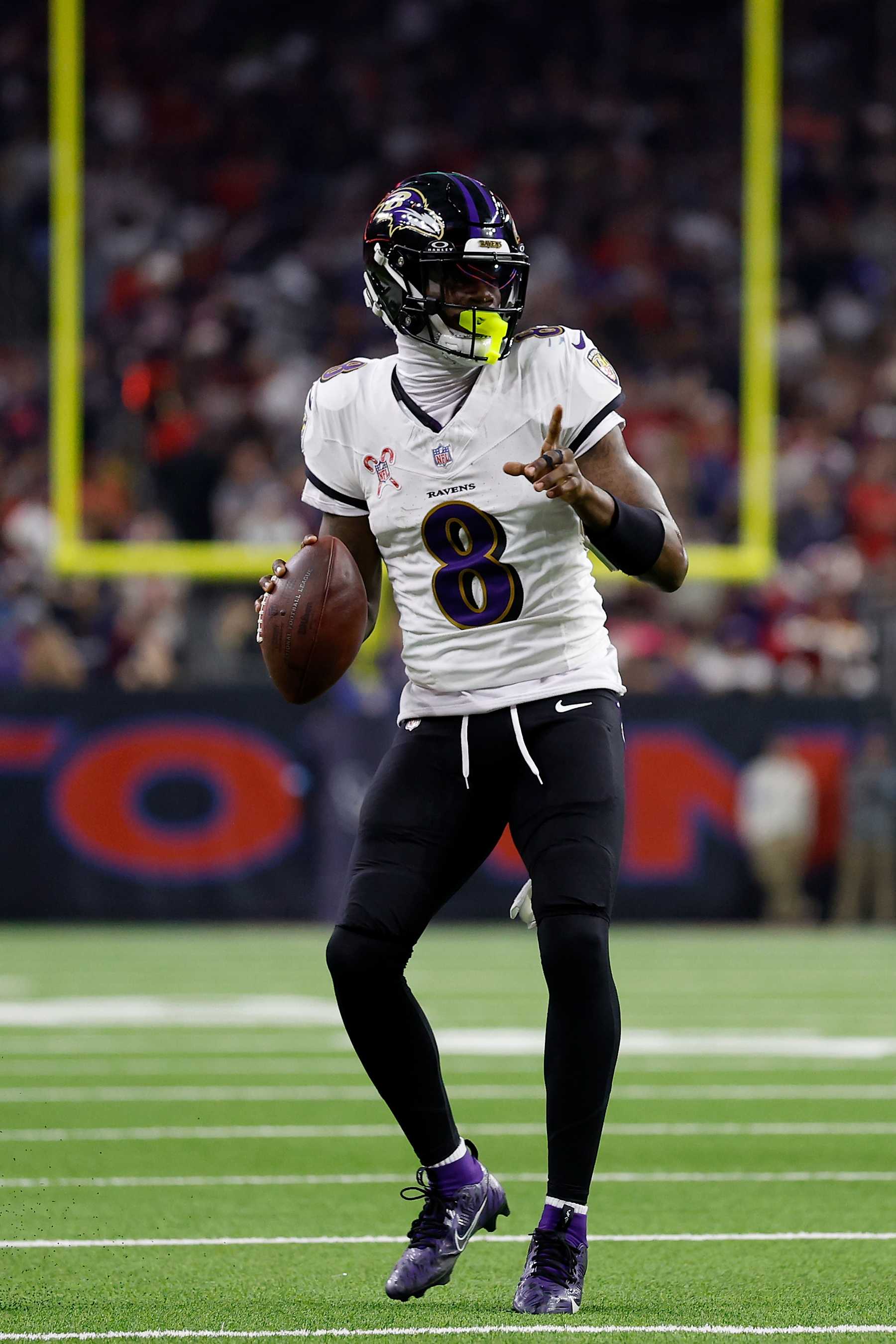 HOUSTON, TEXAS - DECEMBER 25: Lamar Jackson #8 of the Baltimore Ravens looks to pass in the second quarter against the Houston Texans at NRG Stadium on December 25, 2024 in Houston, Texas. (Photo by Tim Warner/Getty Images)