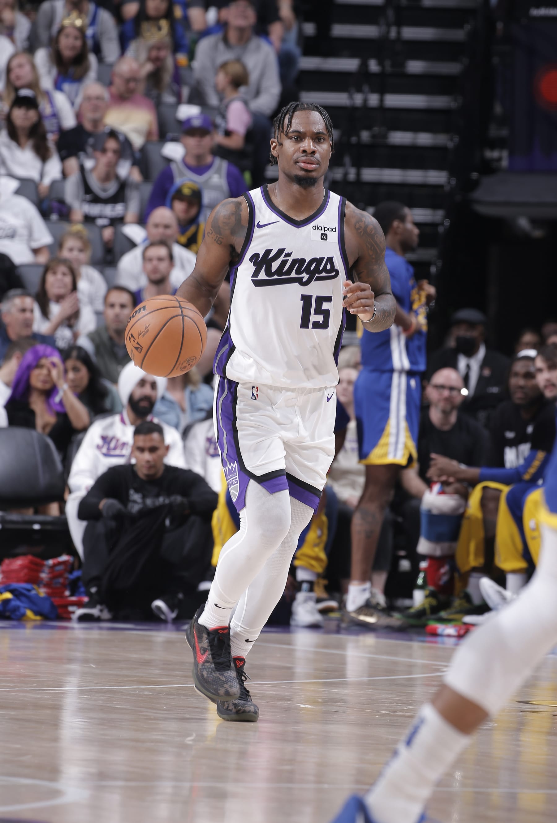 SACRAMENTO, CA - APRIL 16: Davion Mitchell #15 of the Sacramento Kings brings the ball up the court during the game against the Golden State Warriors during the 2024 Play-In Tournament on April 16, 2024 at Golden 1 Center in Sacramento, California. NOTE TO USER: User expressly acknowledges and agrees that, by downloading and or using this photograph, User is consenting to the terms and conditions of the Getty Images Agreement. Mandatory Copyright Notice: Copyright 2024 NBAE (Photo by Rocky Widner/NBAE via Getty Images)