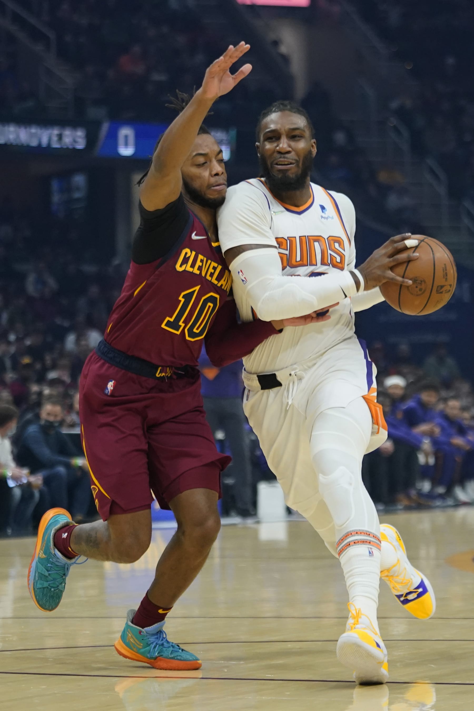 Phoenix Suns' Jae Crowder (99) drives against Cleveland Cavaliers' Darius Garland (10) in the first half of an NBA basketball game, Wednesday, Nov. 24, 2021, in Cleveland. (AP Photo/Tony Dejak)