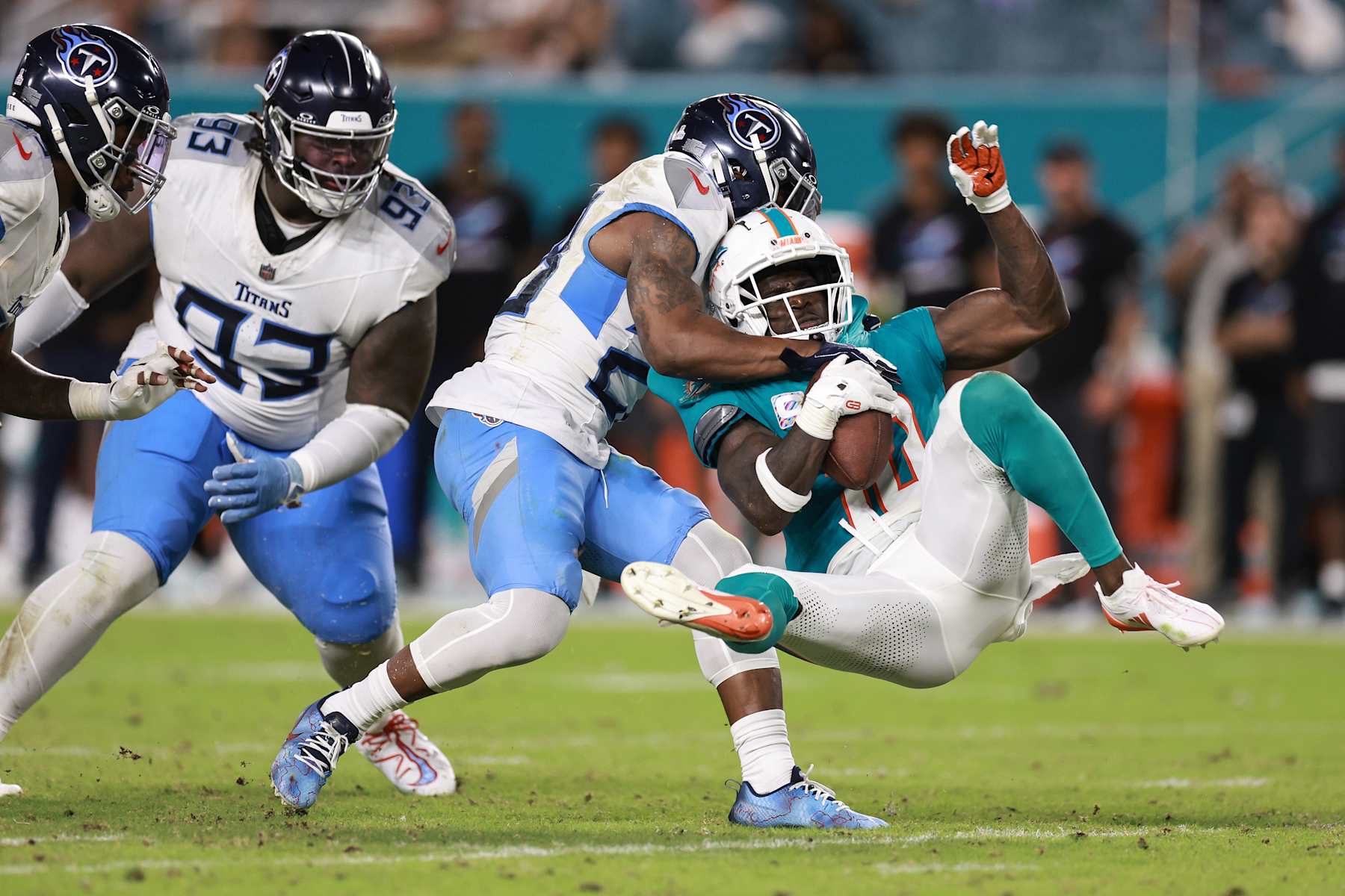 MIAMI GARDENS, FLORIDA - SEPTEMBER 30: Tyreek Hill #10 of the Miami Dolphins is tackled by Quandre Diggs #28 of the Tennessee Titans during the second quarter at Hard Rock Stadium on September 30, 2024 in Miami Gardens, Florida. (Photo by Carmen Mandato/Getty Images)