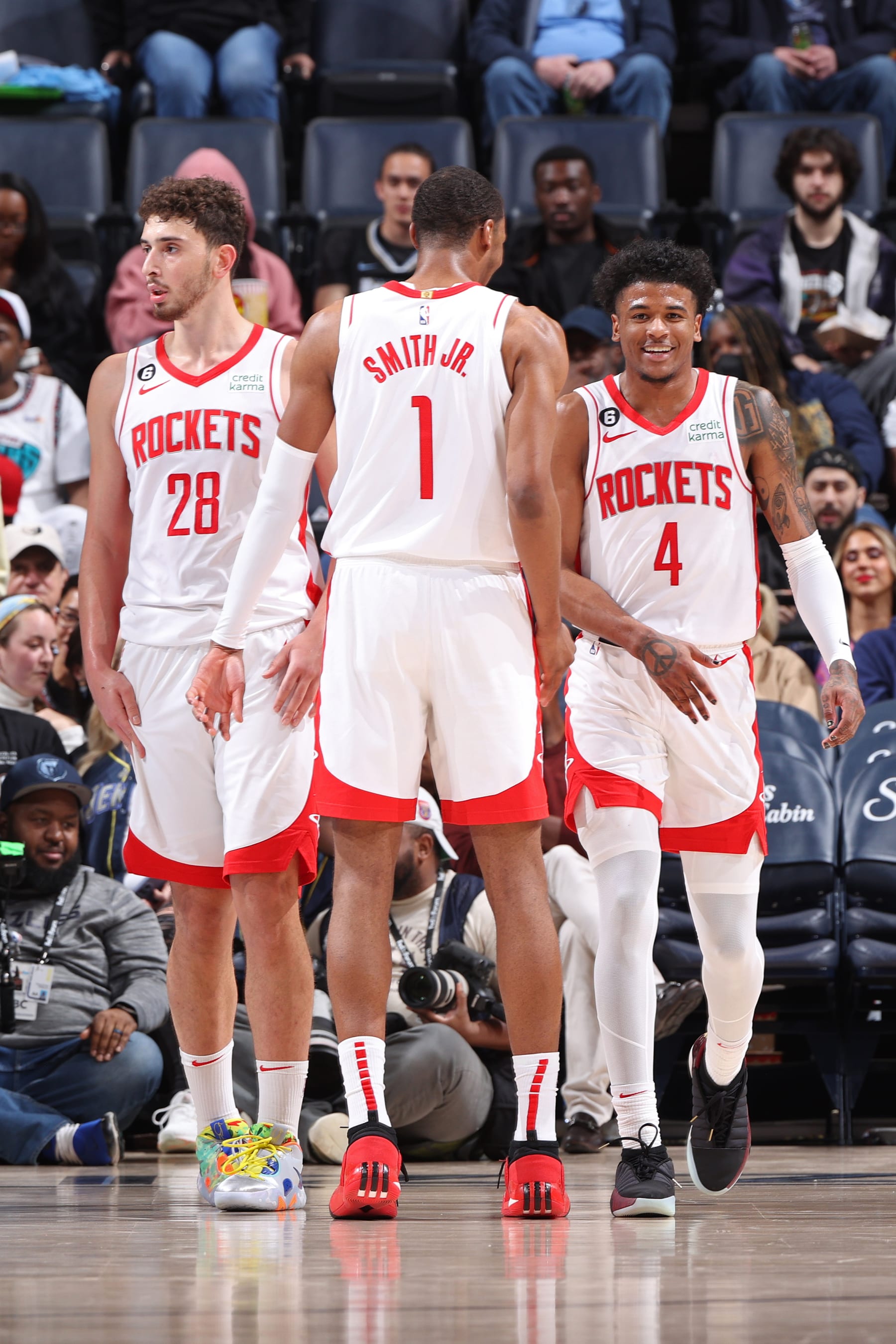 MEMPHIS, TN - MARCH 22:  Alperen Sengun #28, Jalen Green #4 and Jabari Smith Jr. #1 of the Houston Rockets looks on during the game on March 22, 2023 at FedExForum in Memphis, Tennessee. NOTE TO USER: User expressly acknowledges and agrees that, by downloading and or using this photograph, User is consenting to the terms and conditions of the Getty Images License Agreement. Mandatory Copyright Notice: Copyright 2023 NBAE (Photo by Joe Murphy/NBAE via Getty Images)