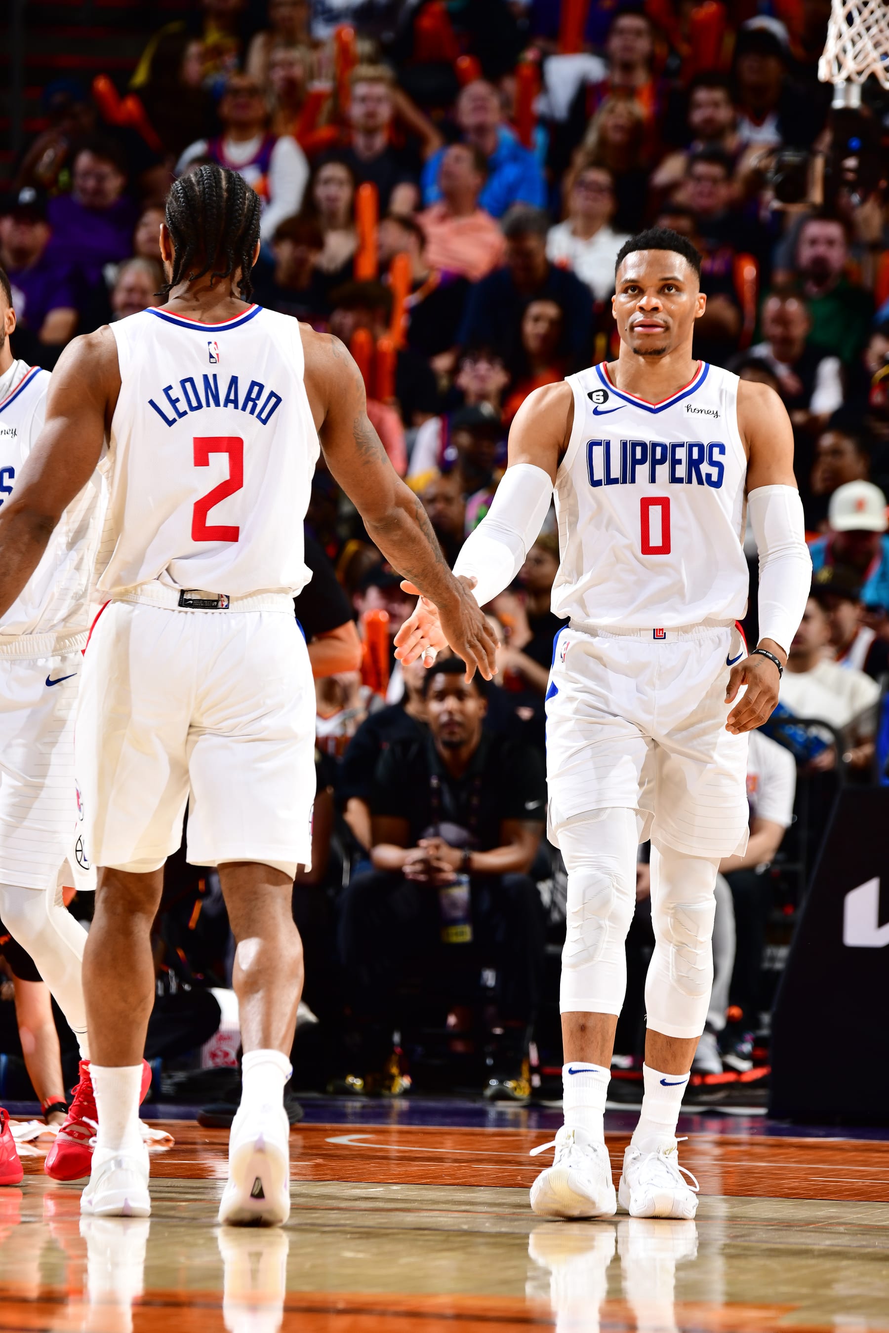 PHOENIX, AZ - APRIL 18: Kawhi Leonard #2 and Russell Westbrook  #0 of the LA Clippers high fives during the game against the Phoenix Suns during Round 1 Game 2 of the 2023 NBA Playoffs on April 18, 2023 at Footprint Center in Phoenix, Arizona. NOTE TO USER: User expressly acknowledges and agrees that, by downloading and or using this photograph, user is consenting to the terms and conditions of the Getty Images License Agreement. Mandatory Copyright Notice: Copyright 2023 NBAE (Photo by Barry Gossage/NBAE via Getty Images)