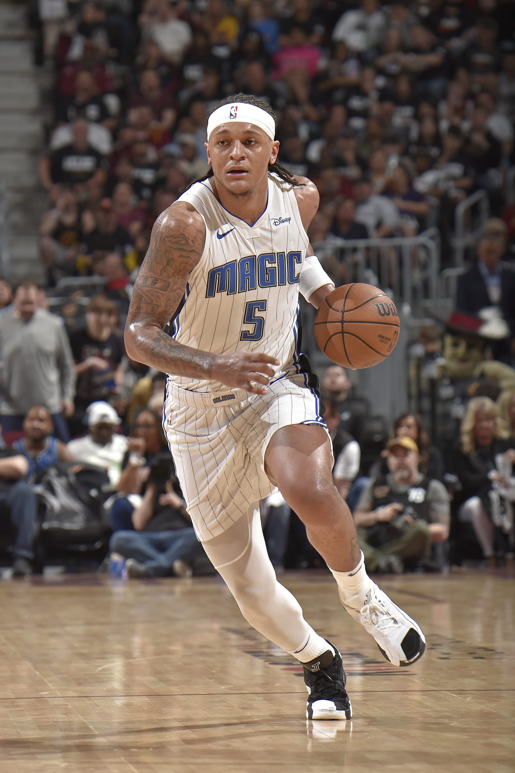 CLEVELAND, OH - MAY 5: Paolo Banchero #5 of the Orlando Magic brings the ball up court during the game against the Cleveland Cavaliers during Round 1 Game 7 of the 2024 NBA Playoffs on May 5, 2024 at Rocket Mortgage FieldHouse in Cleveland, Ohio. NOTE TO USER: User expressly acknowledges and agrees that, by downloading and/or using this Photograph, user is consenting to the terms and conditions of the Getty Images License Agreement. Mandatory Copyright Notice: Copyright 2024 NBAE (Photo by David Liam Kyle/NBAE via Getty Images)