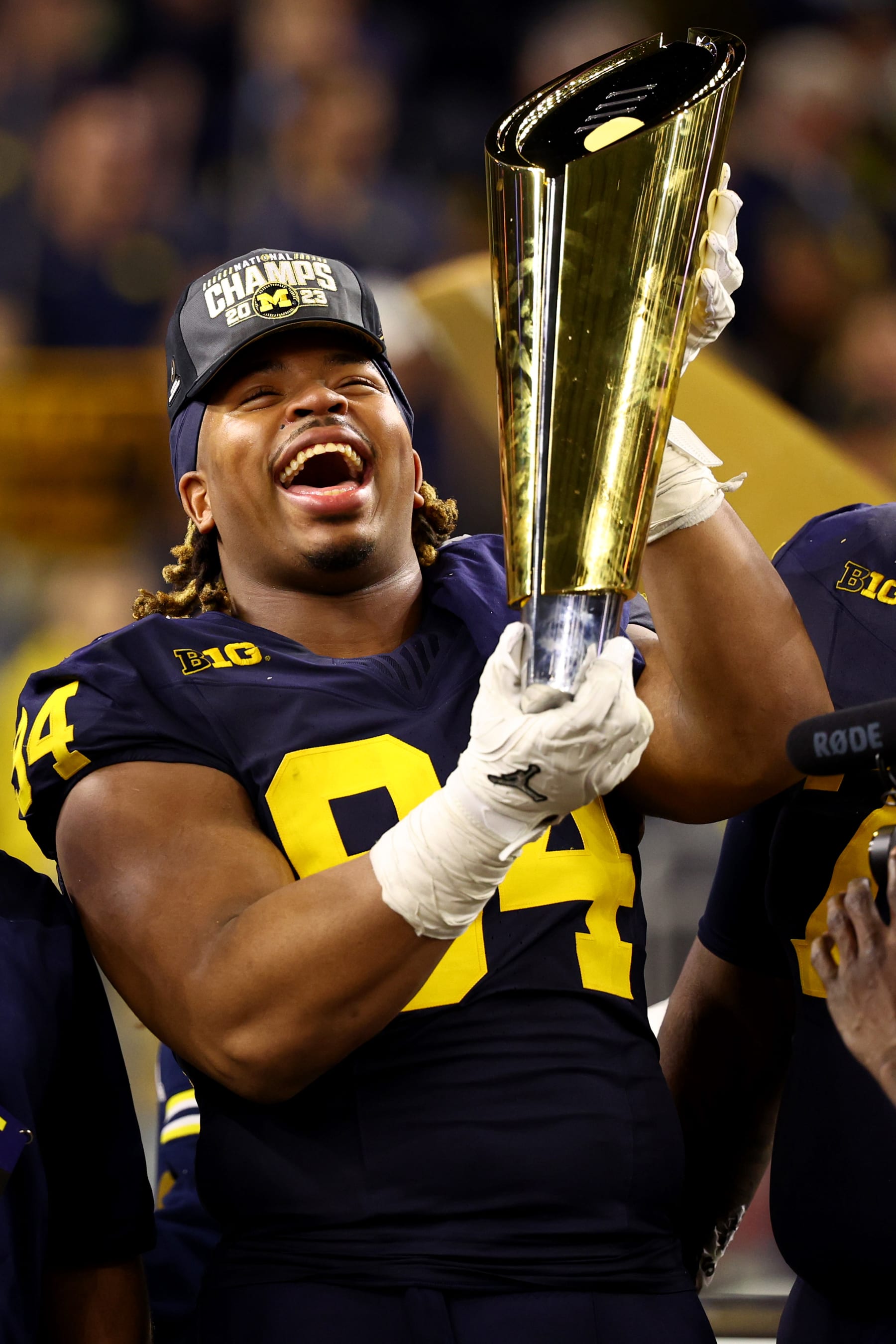HOUSTON, TEXAS - JANUARY 8: Kris Jenkins #94 of the Michigan Wolverines celebrates with the trophy after defeating the Washington Huskies during the 2024 CFP National Championship game at NRG Stadium on January 8, 2024 in Houston, Texas. (Photo by Jamie Schwaberow/Getty Images)